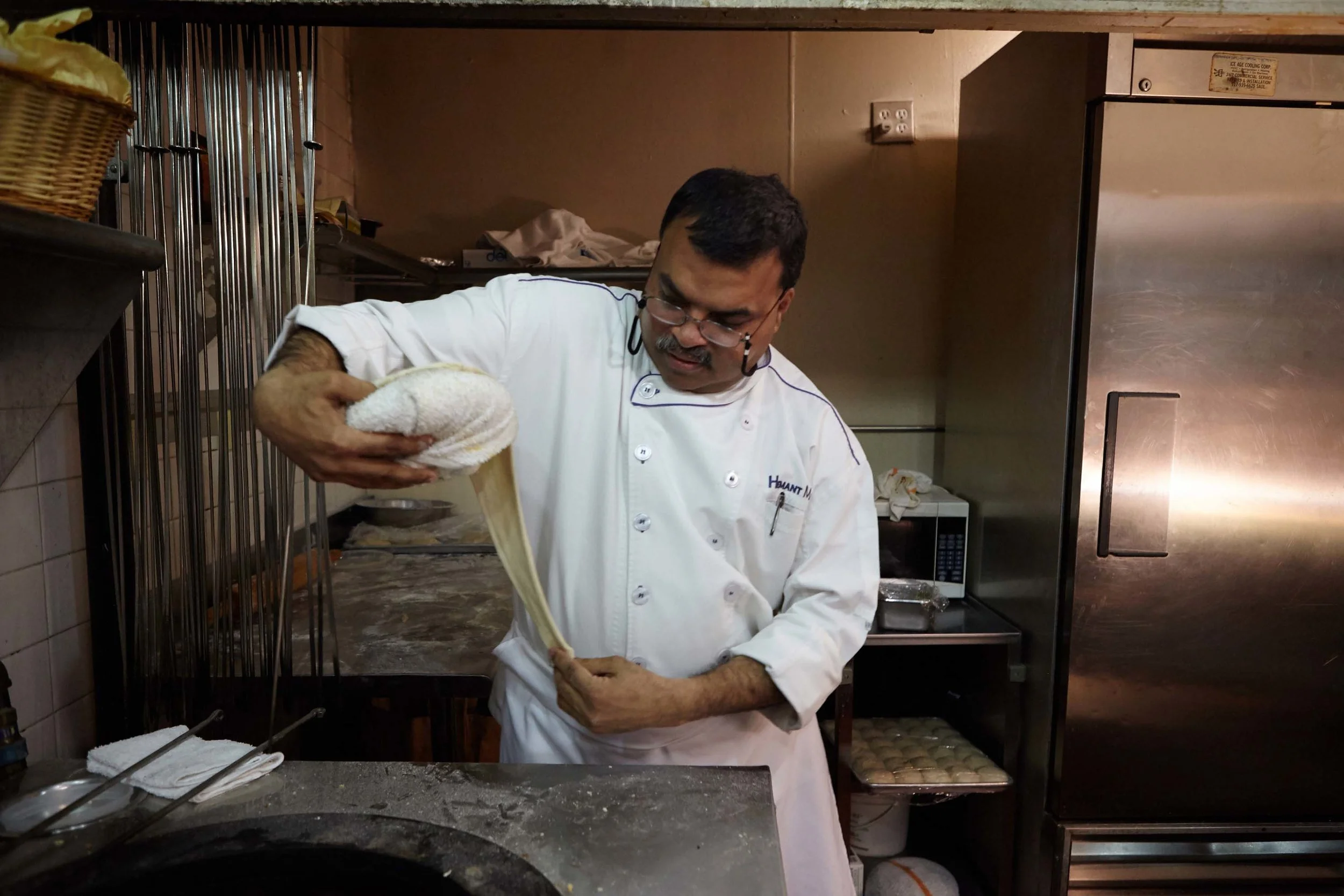 Head Chef Hemant Mathur of Sahib restaurant pulls out bread dough.