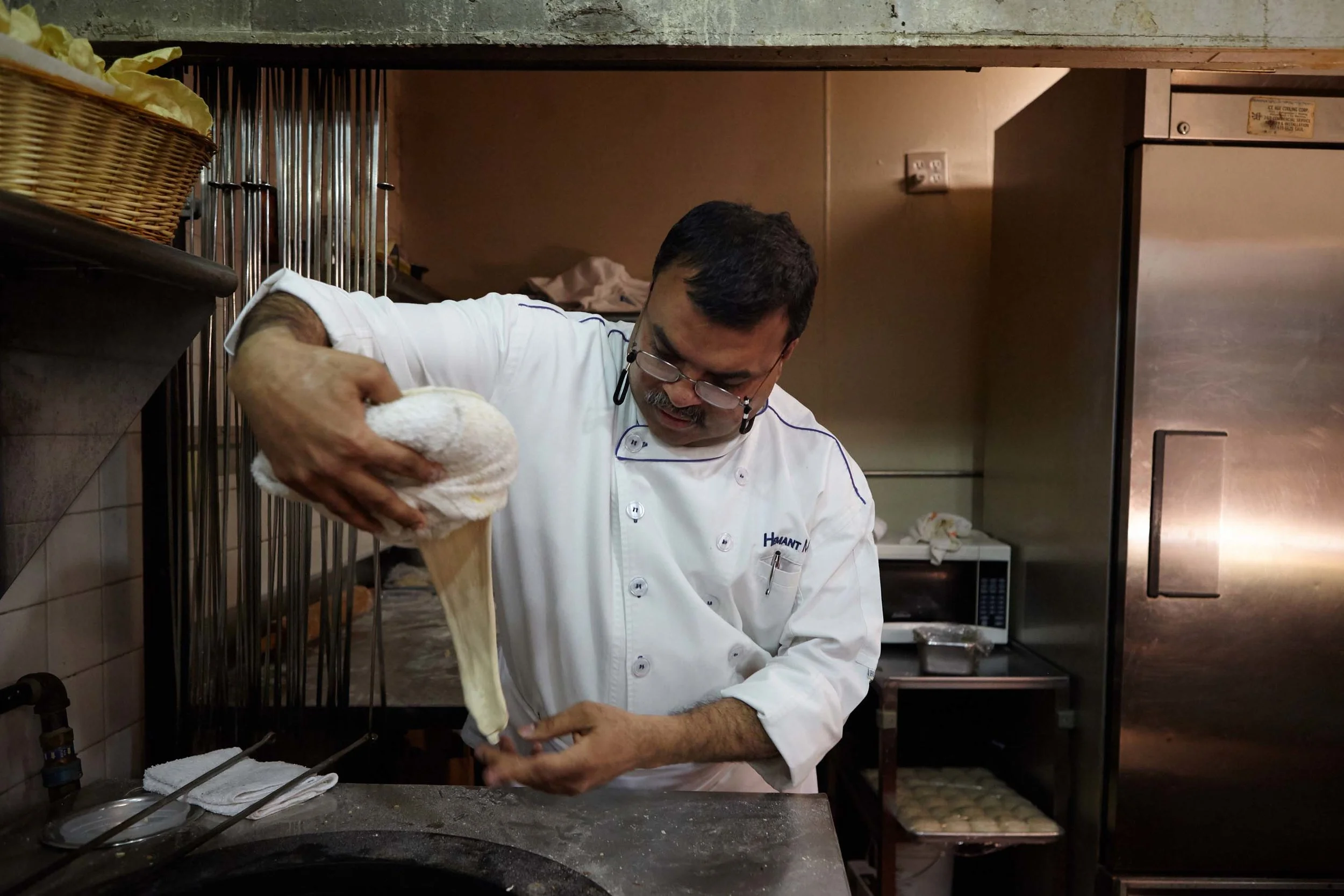 Head Chef Hemant Mathur of Sahib restaurant pulls out bread dough.
