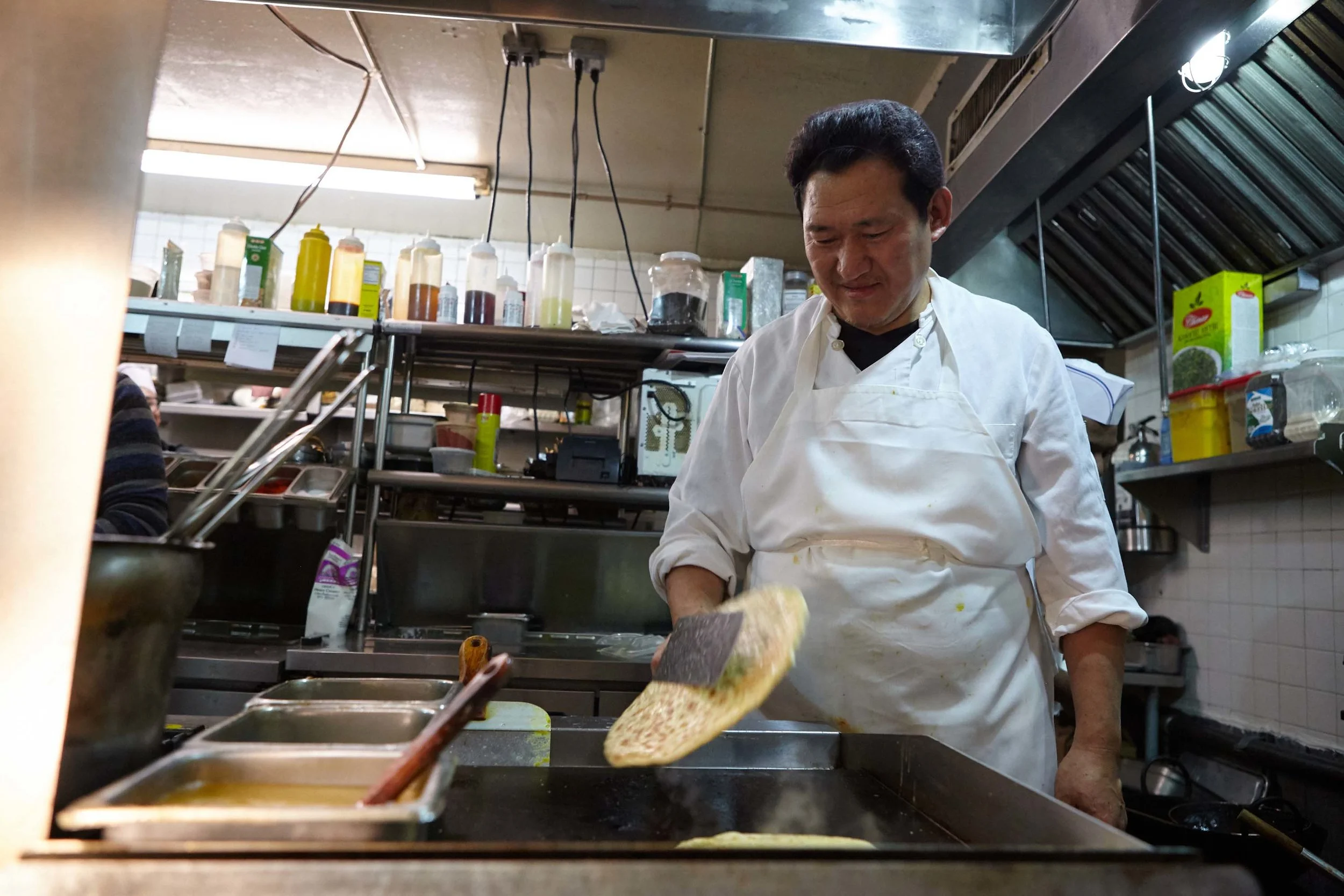 Chef Dimitri Nyimatering flips bread at Sahib restaurant. (not head chef)