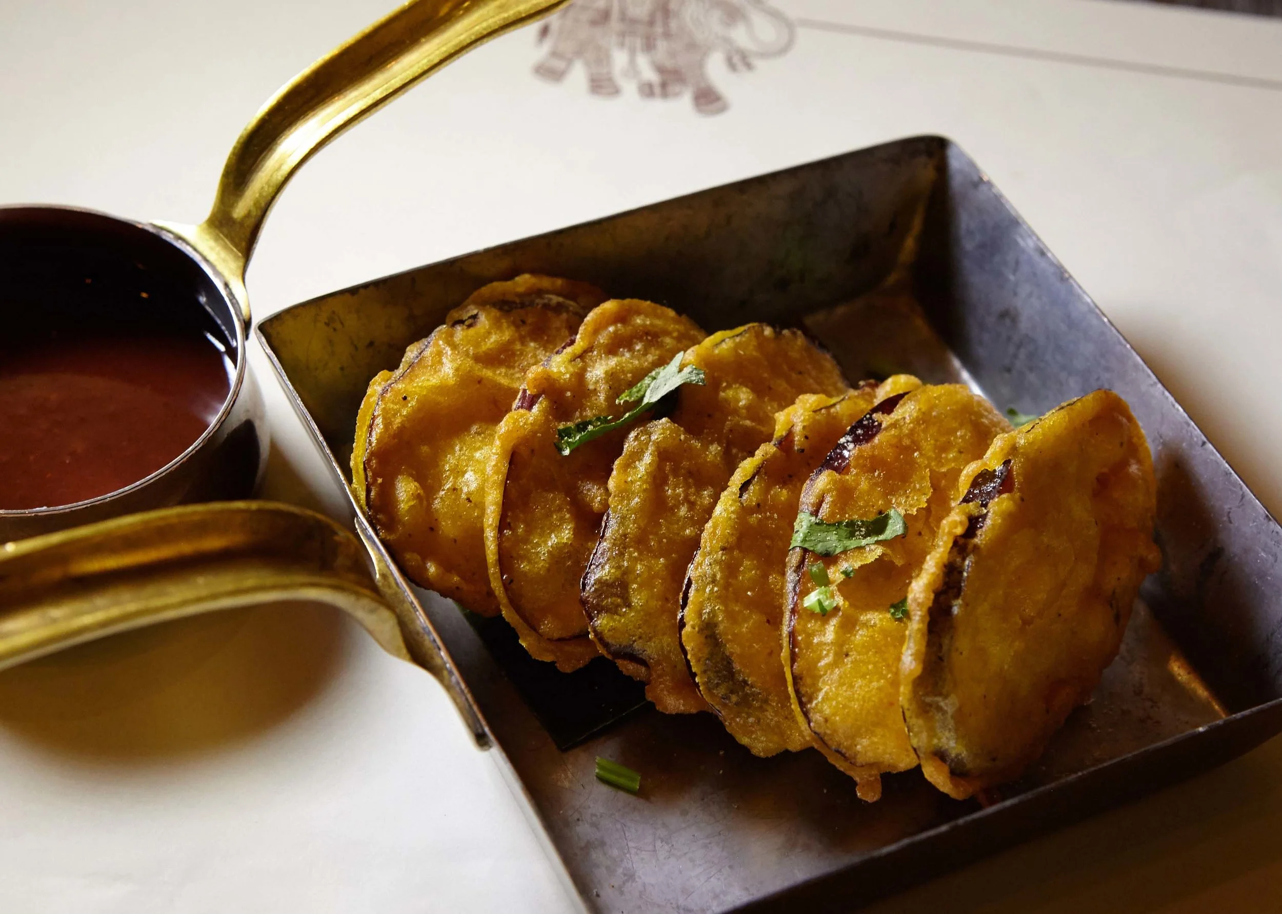 Baighan bhaji (eggplant fritters) with sauce at Sahib restaurant.