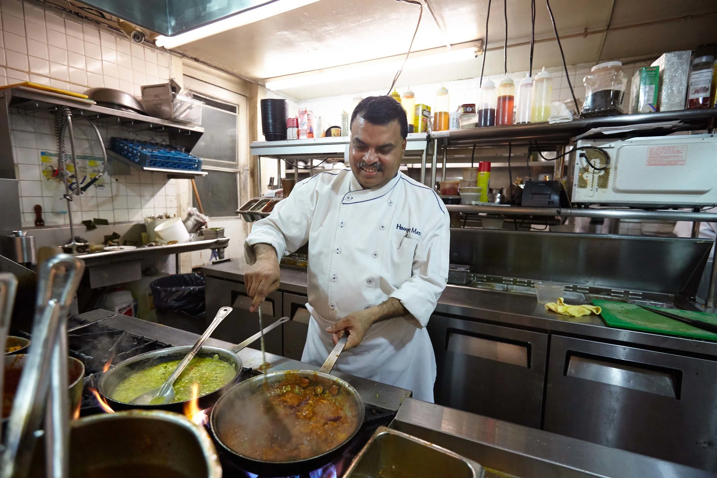 Head Chef Hemant Mathur of Sahib restaurant cooking in the kitchen.