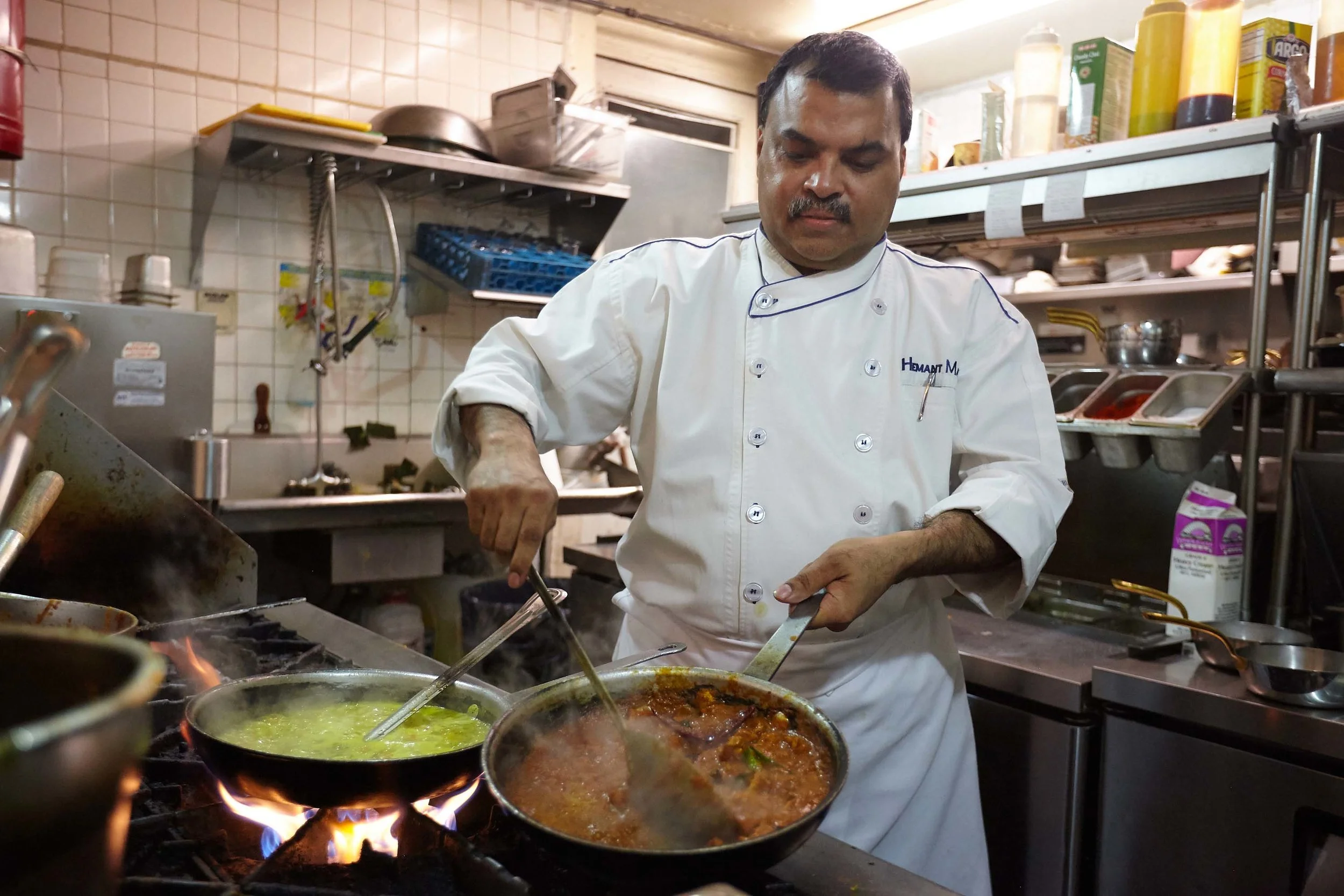 Head Chef Hemant Mathur of Sahib restaurant cooking in the kitchen.