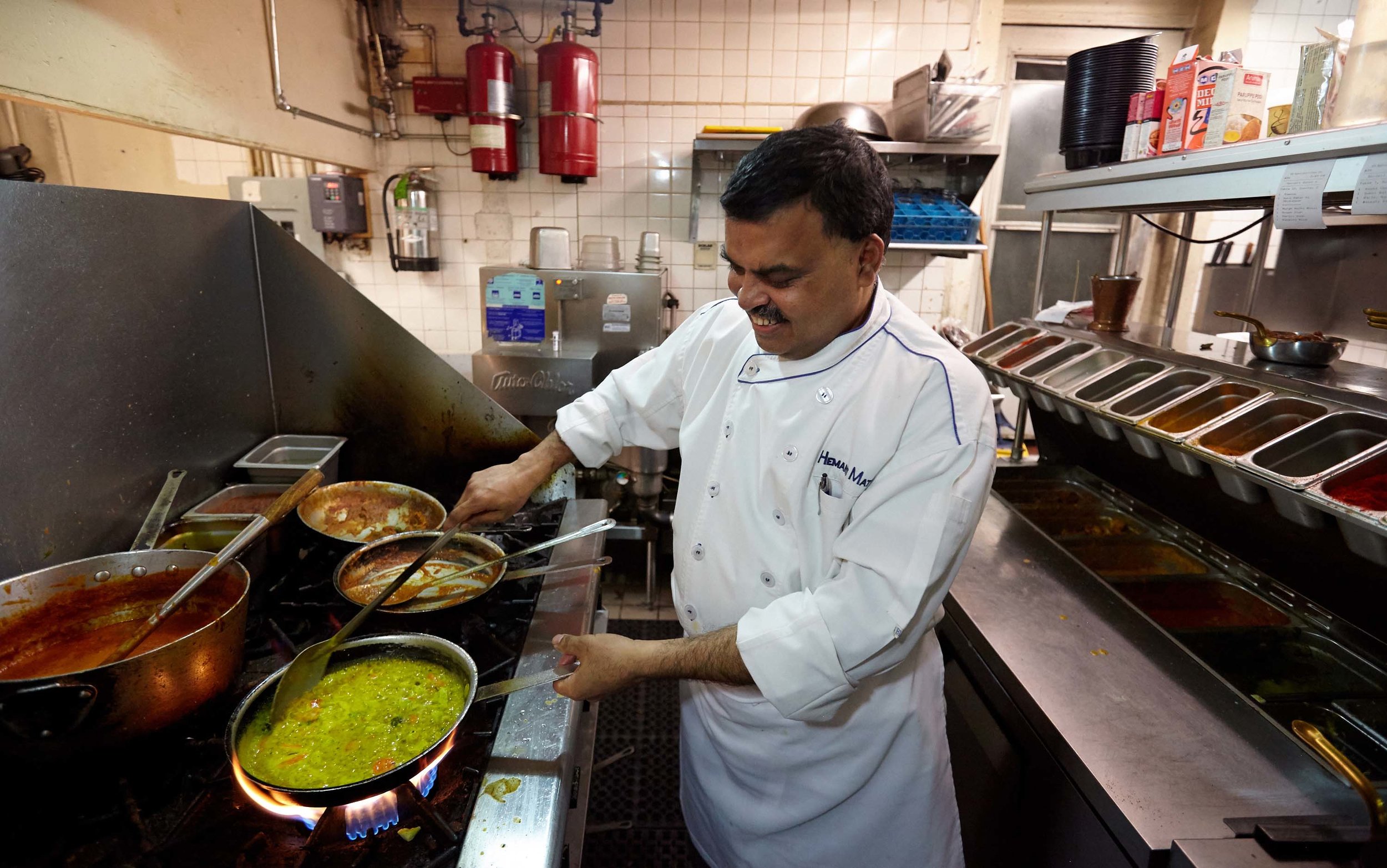 Head Chef Hemant Mathur of Sahib restaurant cooking in the kitchen.