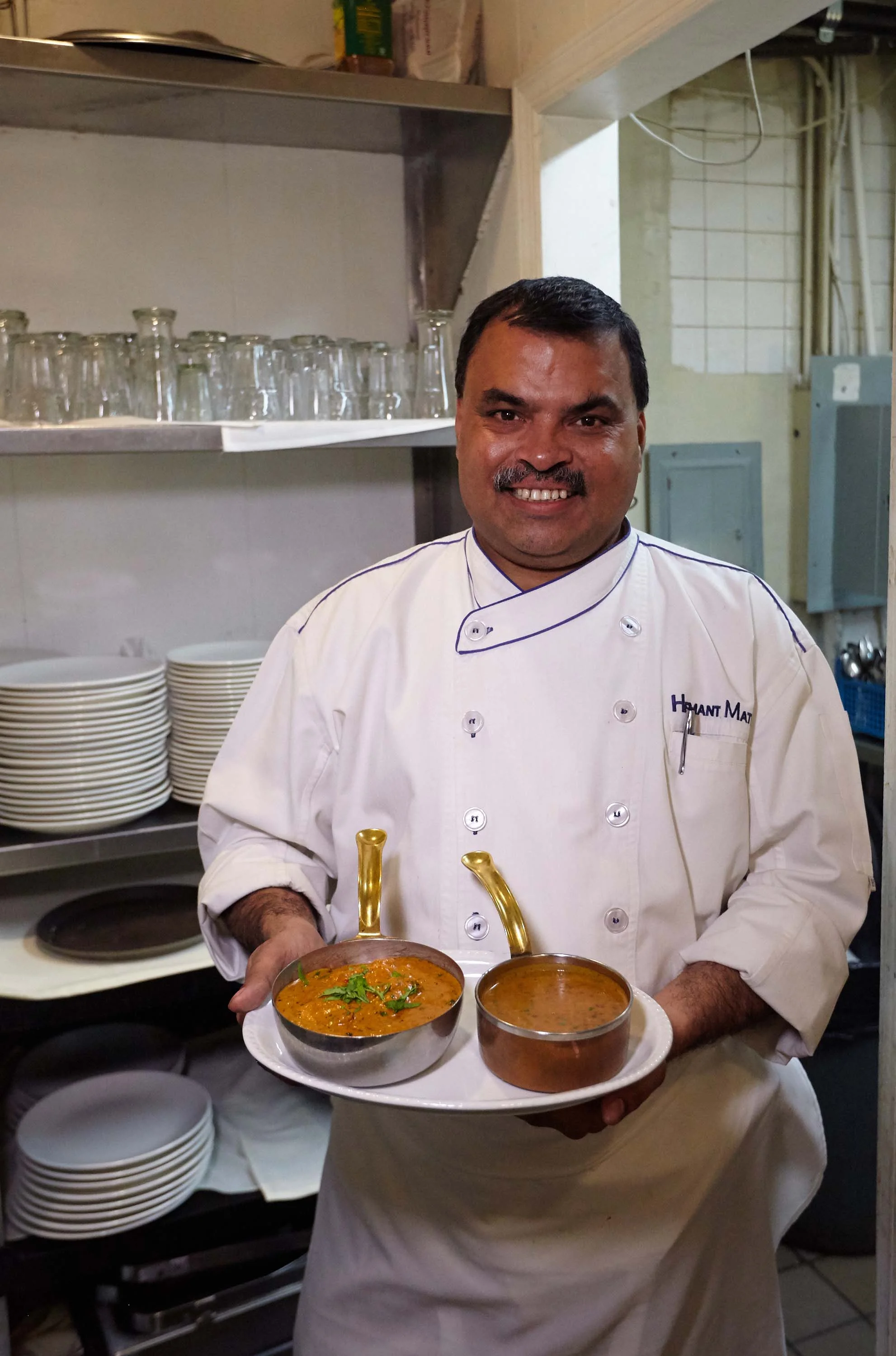 Head Chef Hemant Mathur of Sahib restaurant holding tray of food.