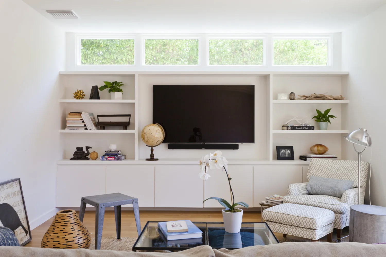 AFTER - We designed the open shelving and custom cabinetry, which holds games, books, DVD's, TV equipment, art supplies... - photo by Heather Culp