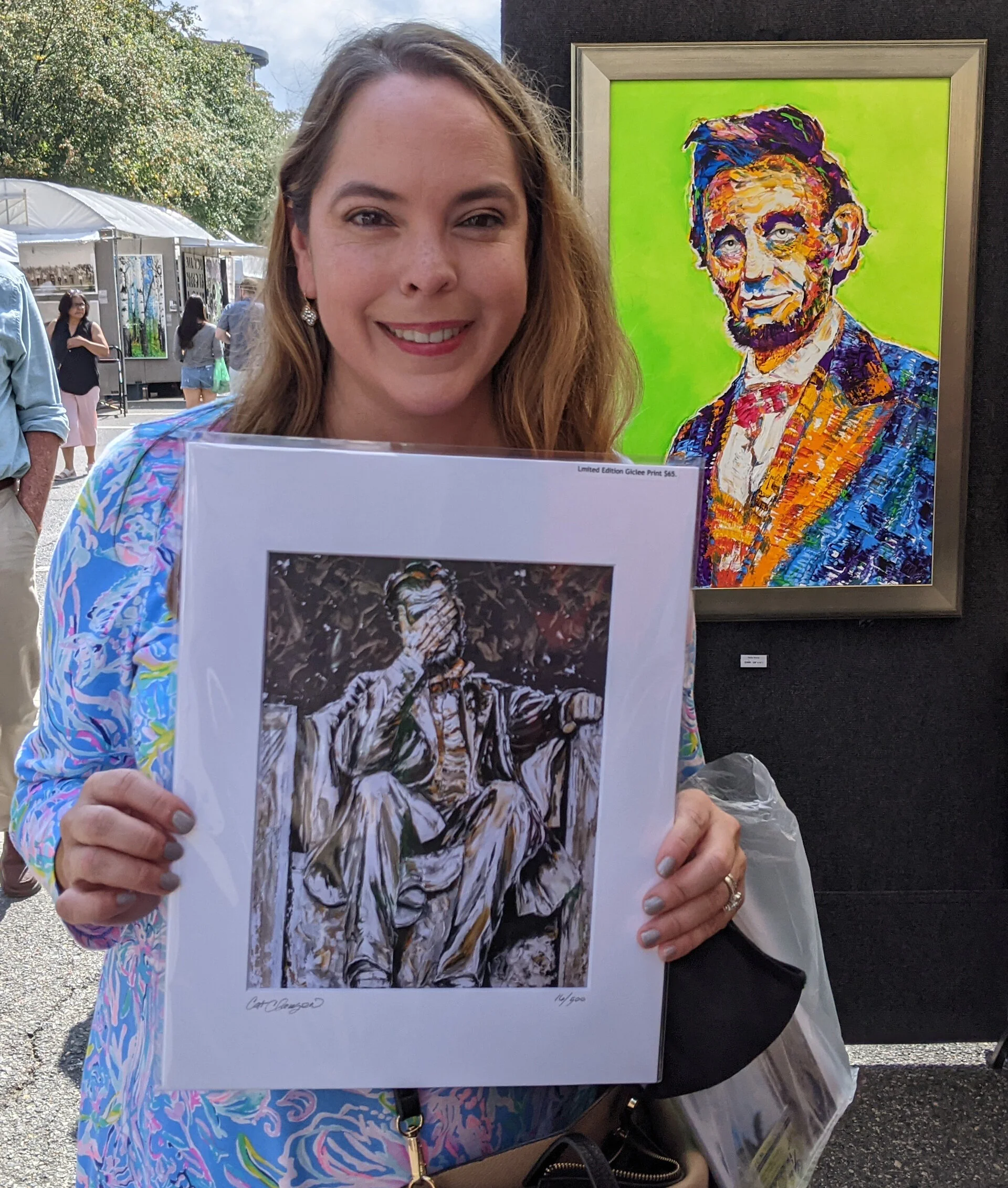 Olivia Troye with her "LINCOLN: Better Days" print on paper; Alexandria, VA, Fall Festival 2021