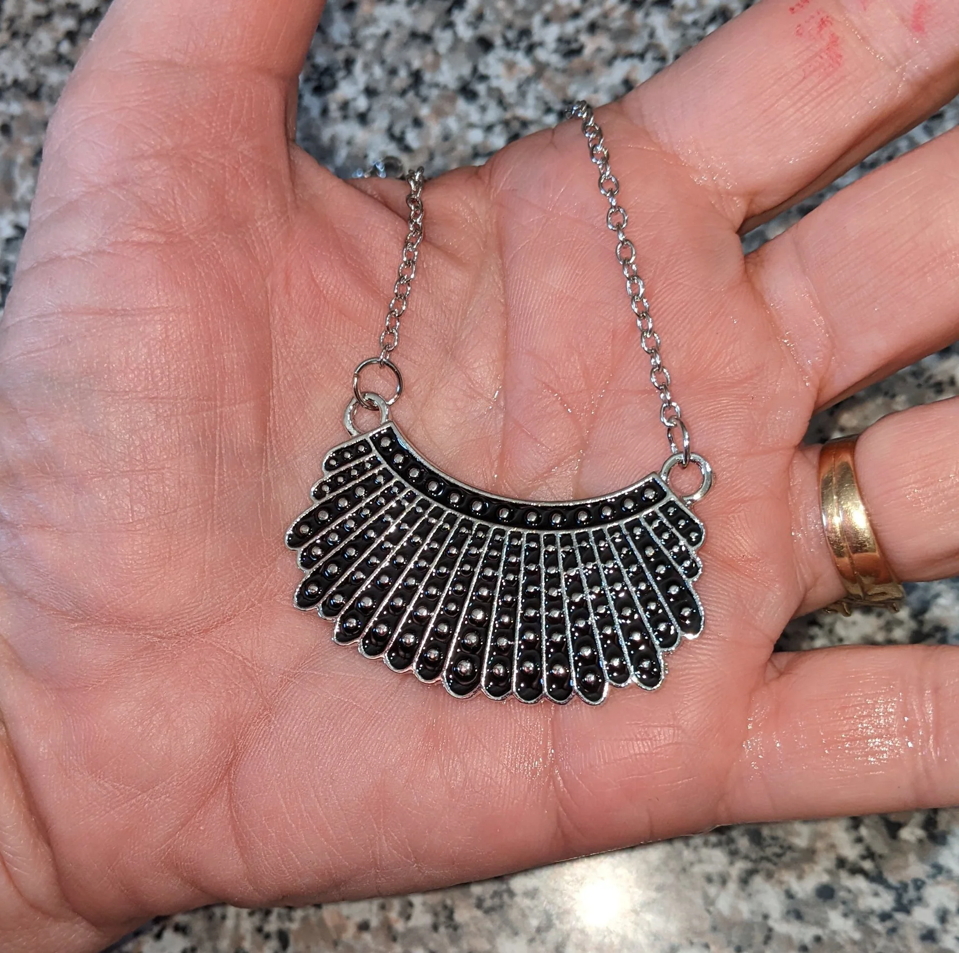 rbg dissent necklace on hand for scale .JPG