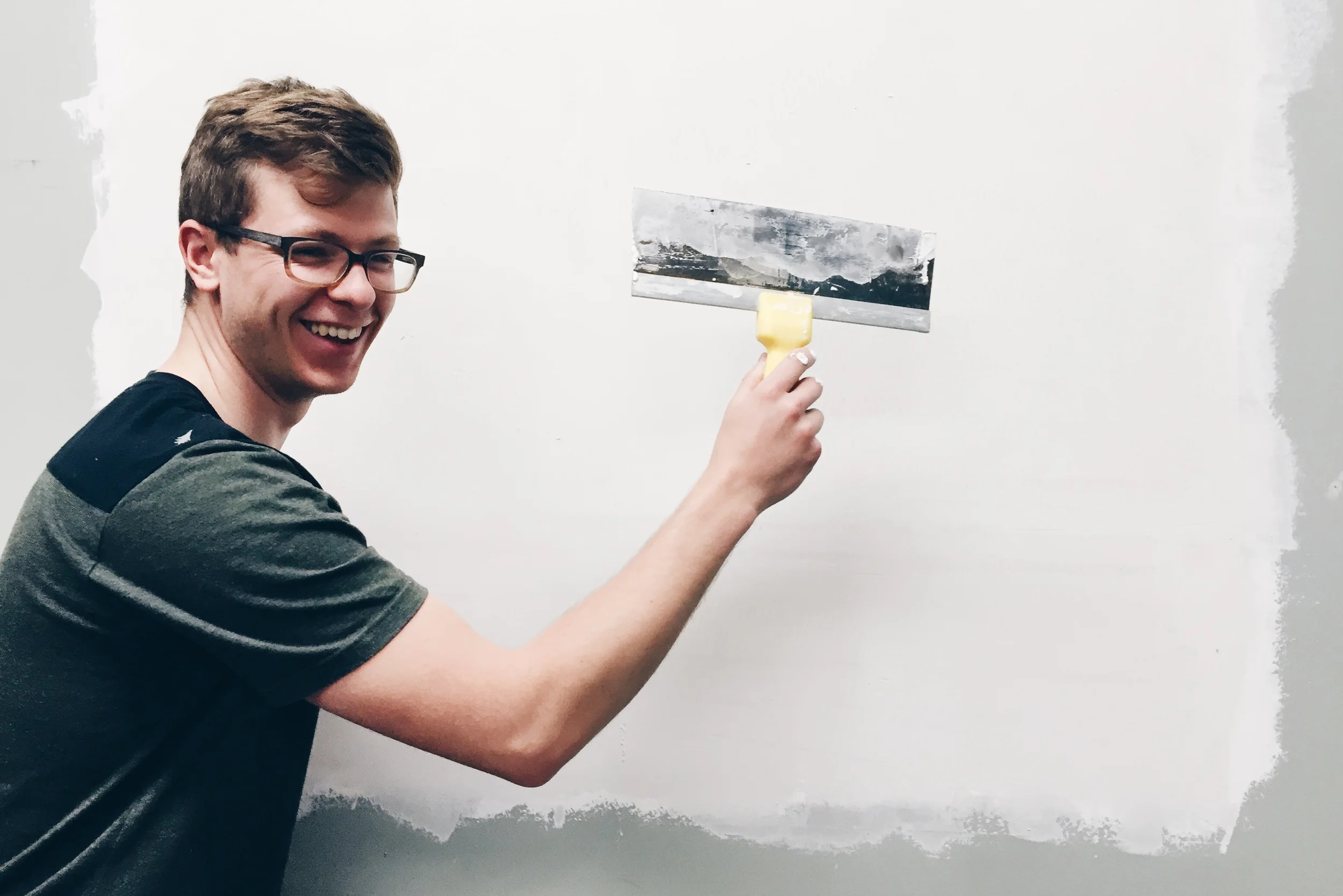 Joey Zingarelli patching the wall 