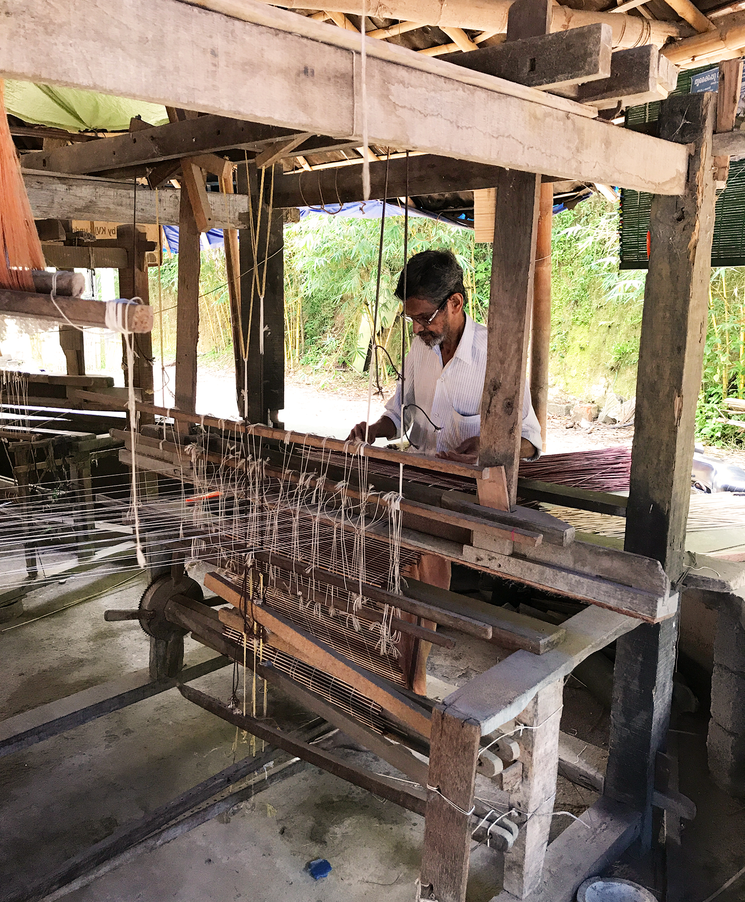 Looming a bamboo mat. 