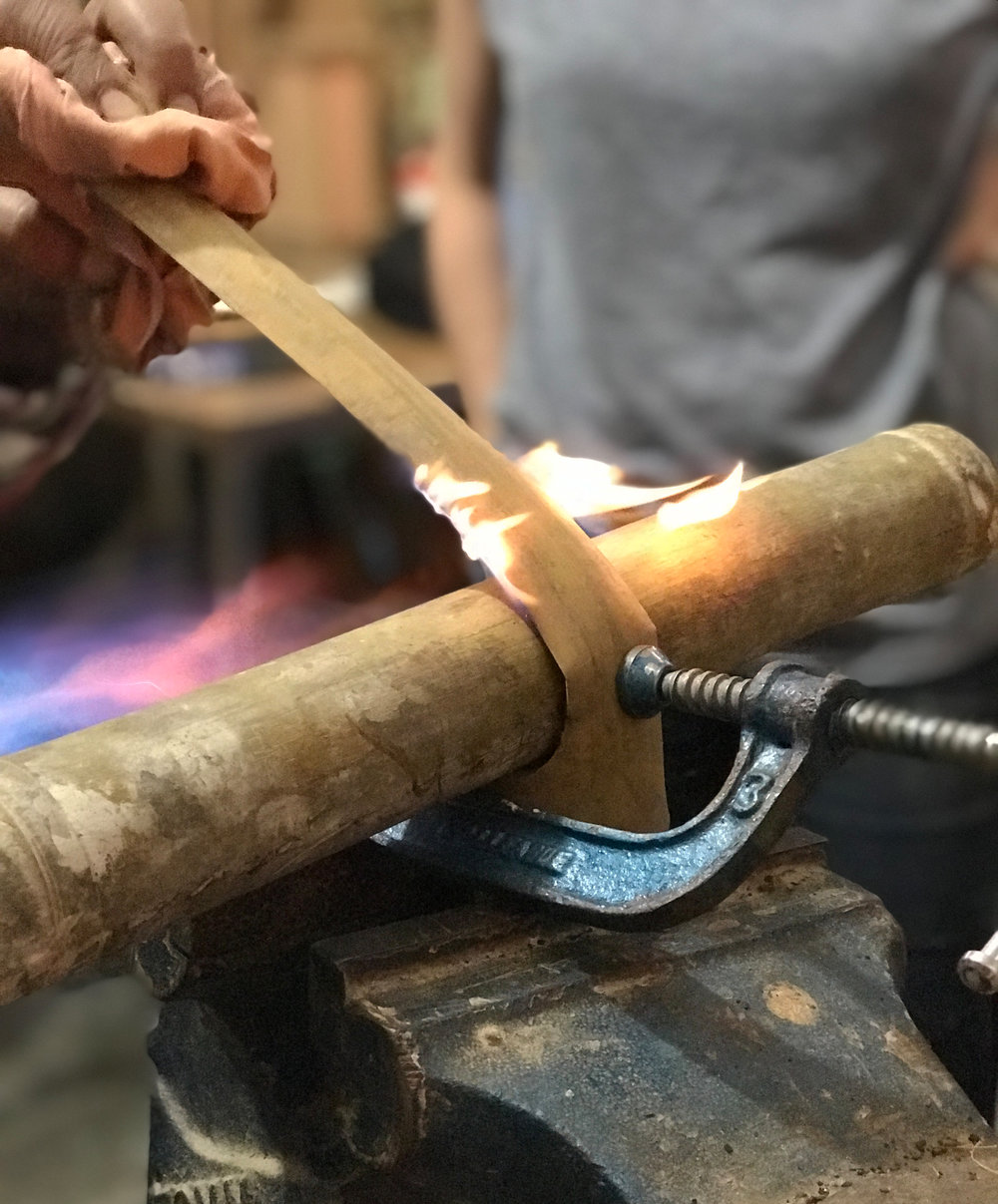 Bending bamboo with heat.