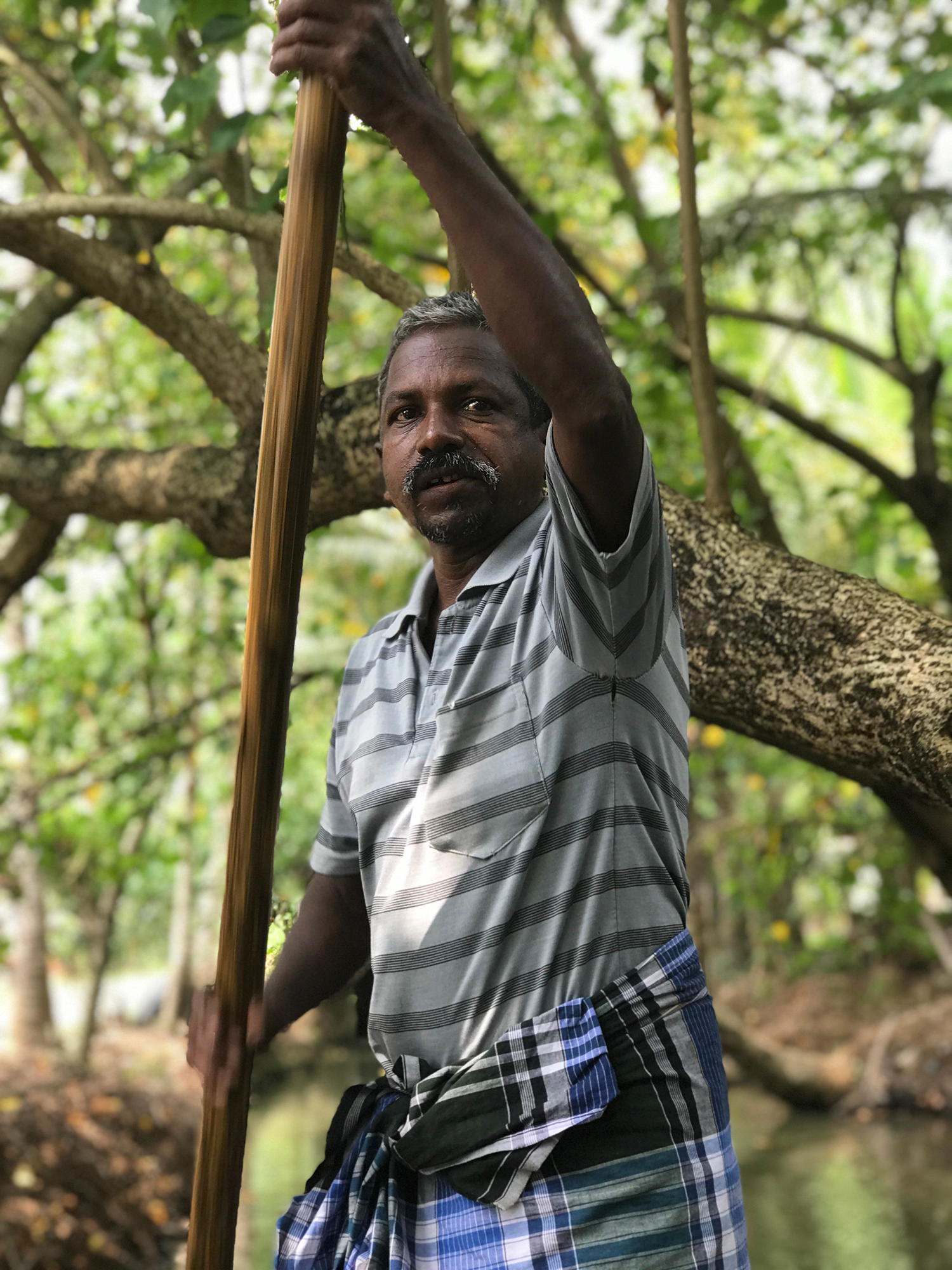 Boater in the backwaters, Munroe Island