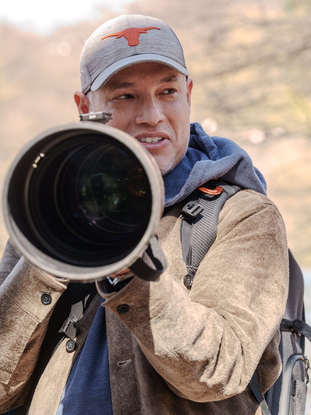 Tony Northrup holding a camera with a long telephoto lens