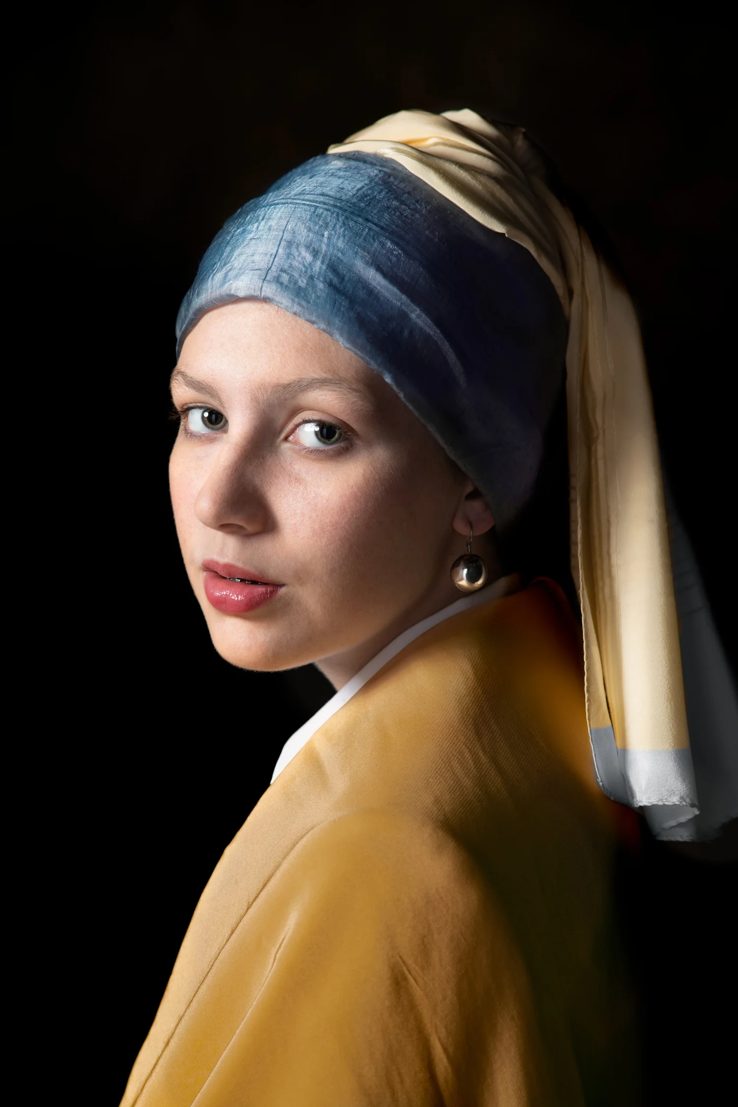 Portrait after Vermeer’s Girl with a Pearl Earring: blue and gold headscarf, pearl earring, dark background