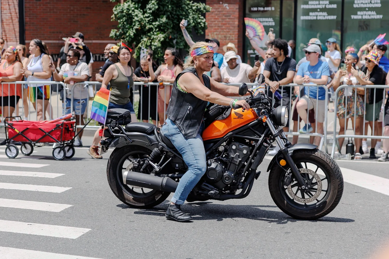 Motorcyclist riding past spectators lining the route