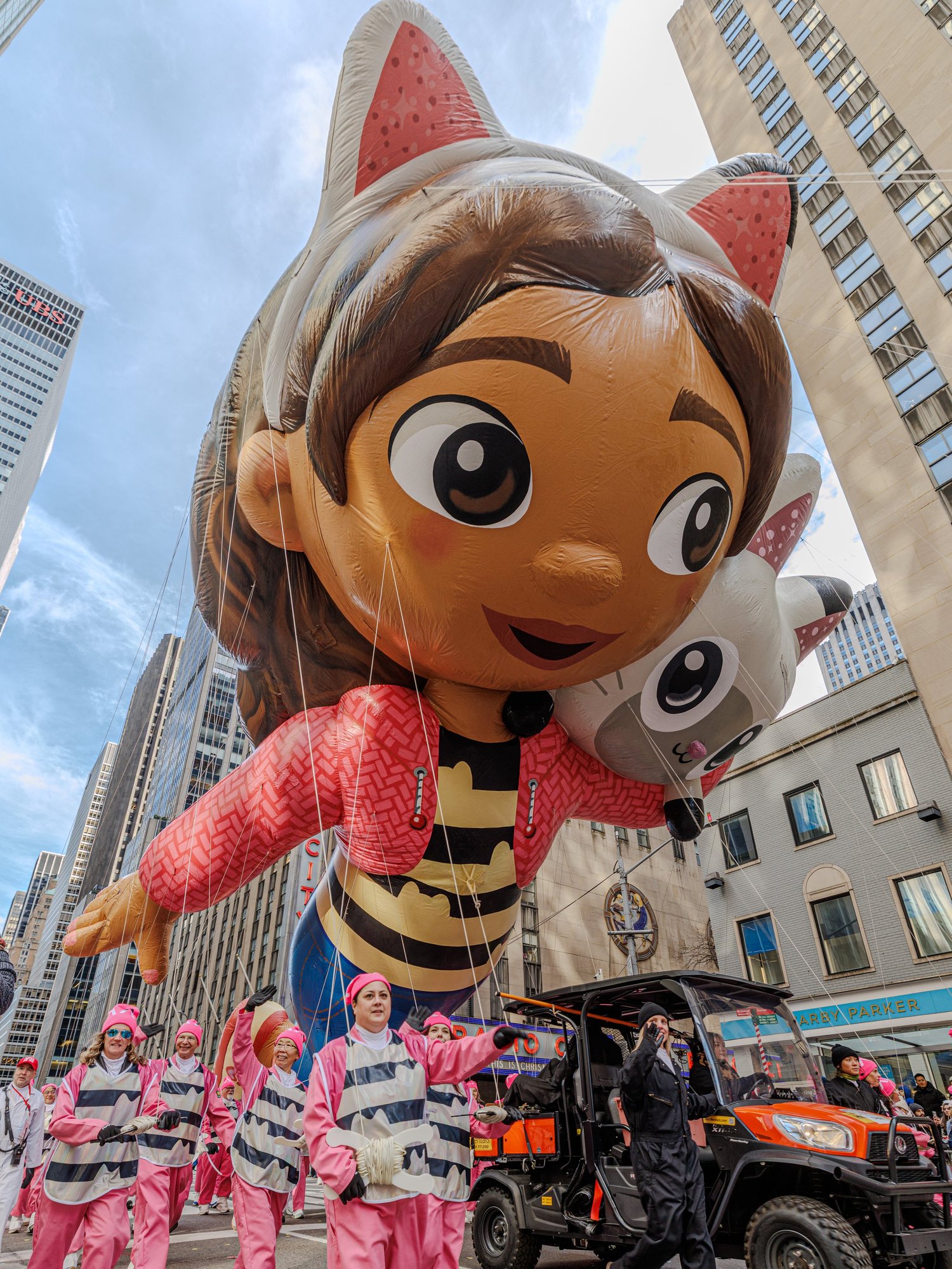 Giant balloon of a cartoon girl with cat ears above the crowd