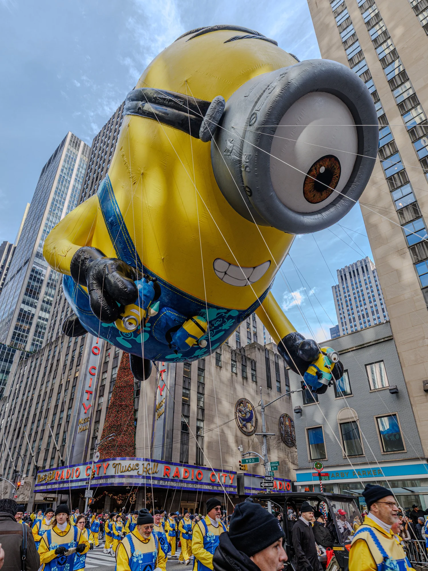 Giant Minion balloon floating between skyscrapers