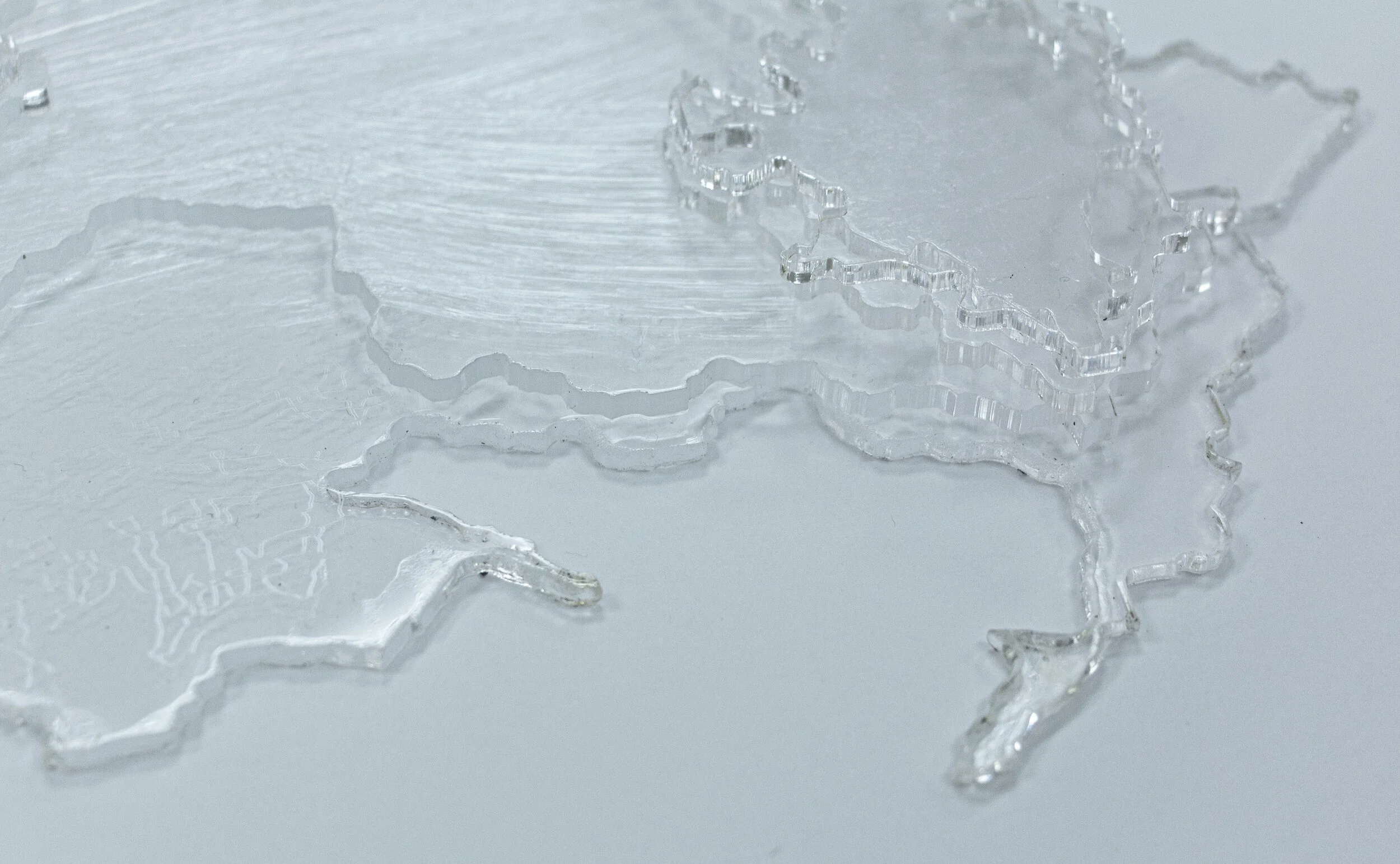 Anne Shine - "A Timelapse (detail)"; Laser etched/cut acrylic of six images of an Alaskan glacier taken from Google Earth Timelapse feature