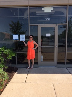 Jennifer Stockhausen rockin' her first building permit in her tangerine power dress.