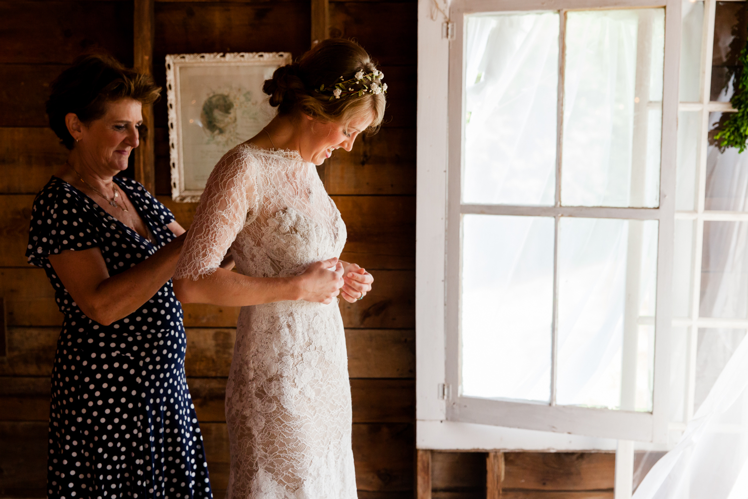  A mother helps the bride with her dress 