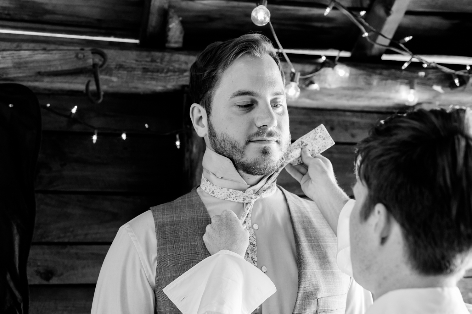  groom get's his bow tie put on. 
