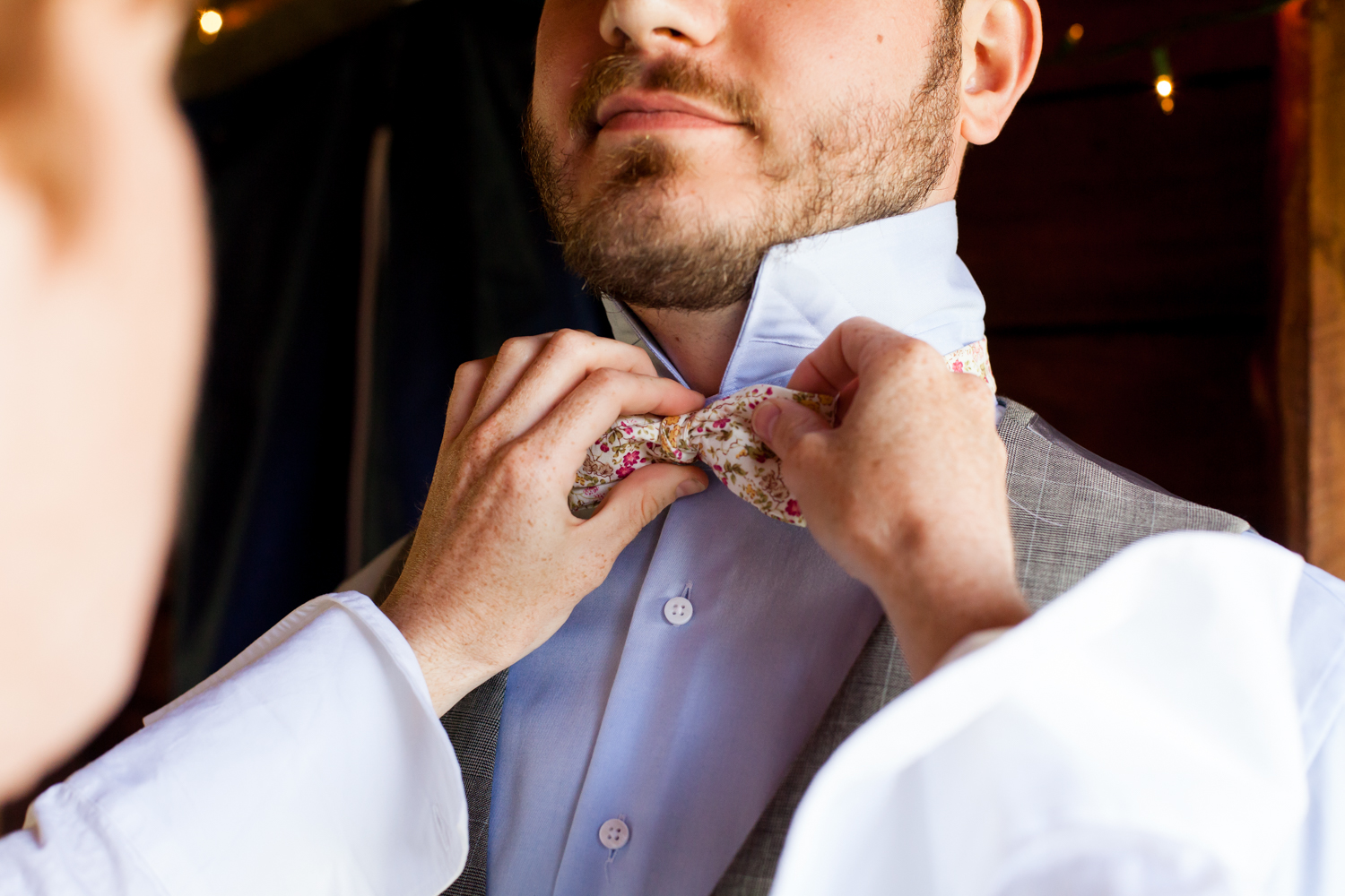  A close up of the grooms bow tie. 