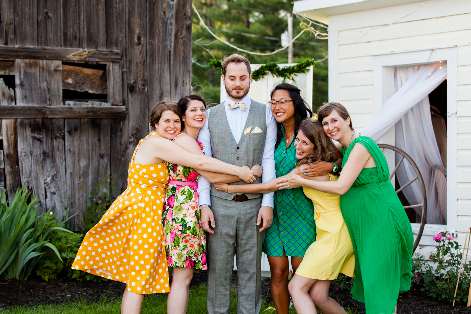 Groom stands with bridesmaids 