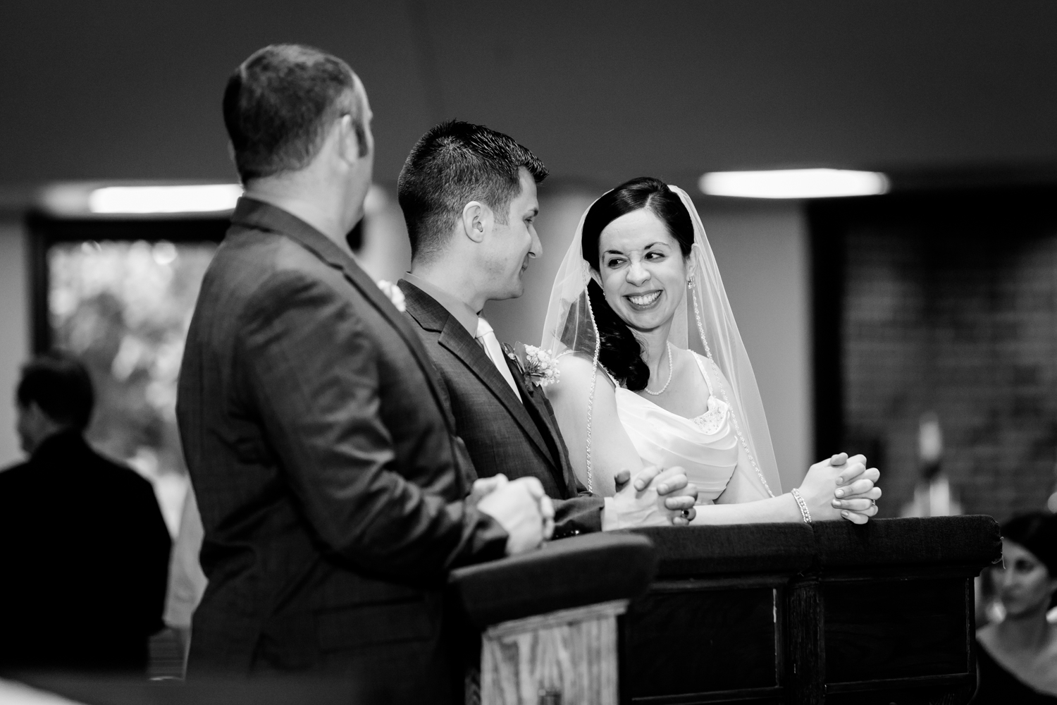  Bride smiles at groom during ceremony 