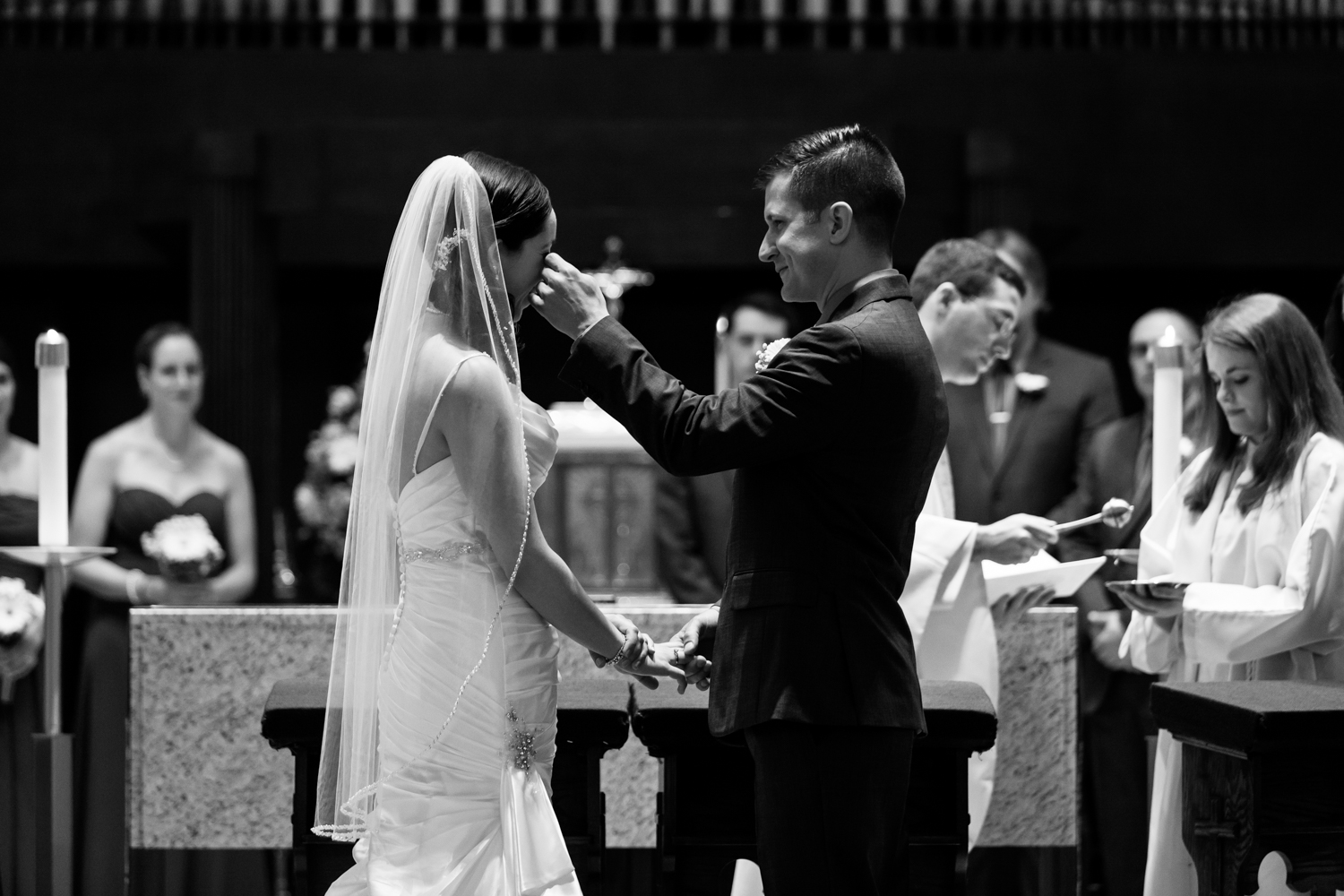  A groom wipes away a tear during the wedding ceremony 