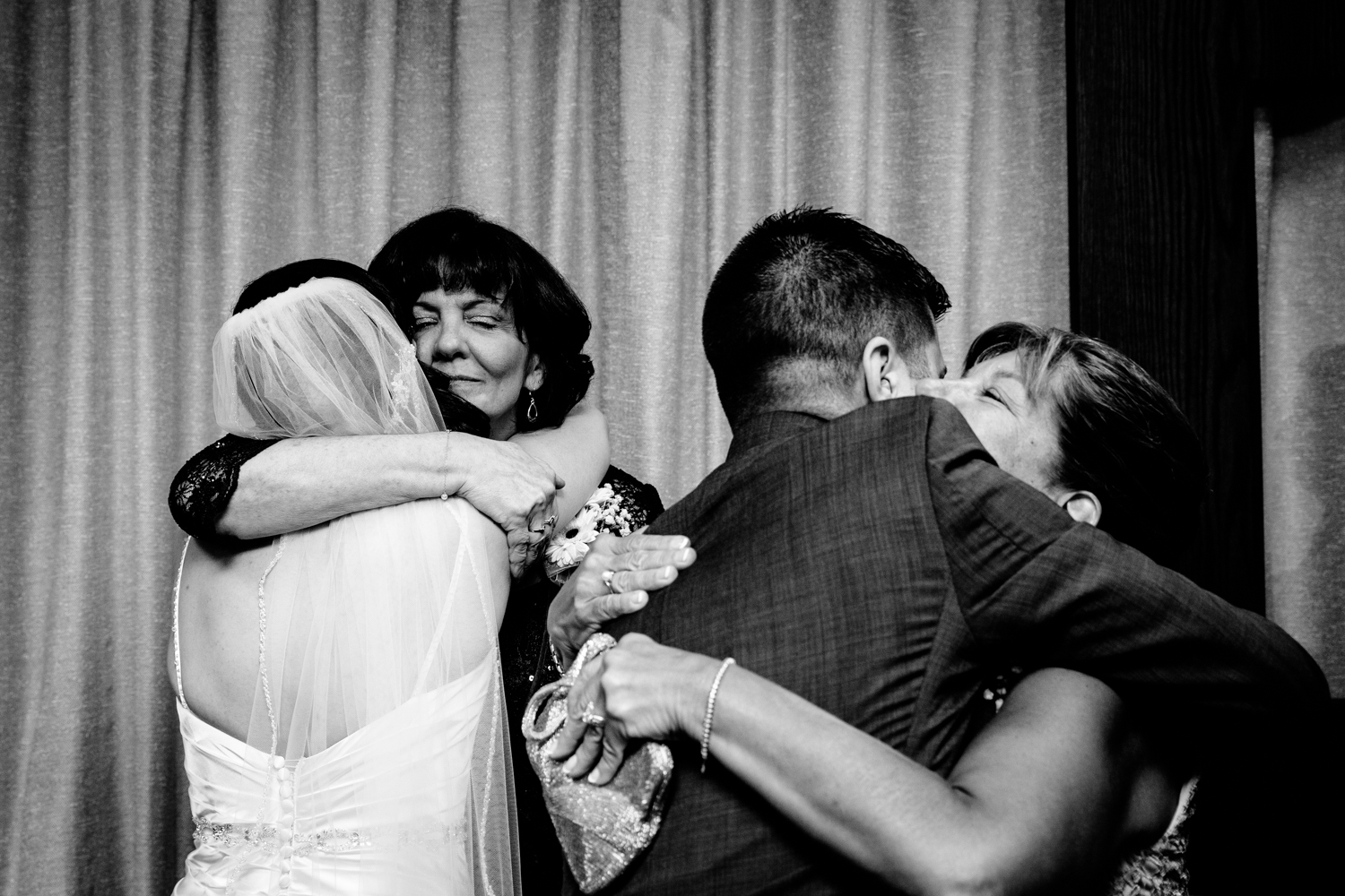  The bride and groom hug their mothers after the ceremony 