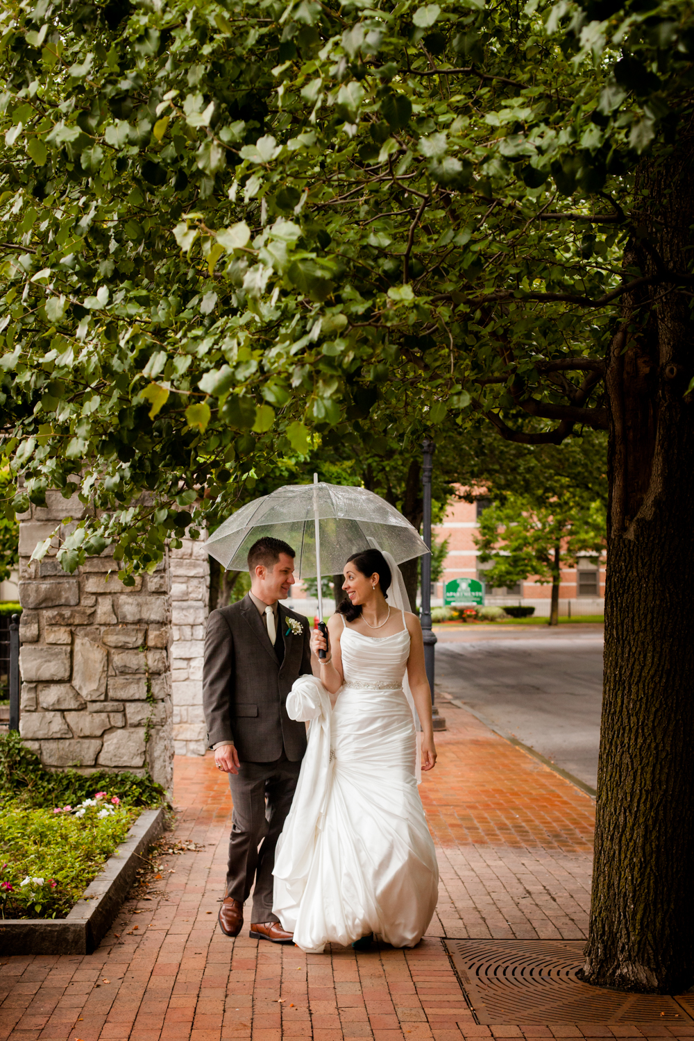  Bride and groom share a moment under an umbrella 