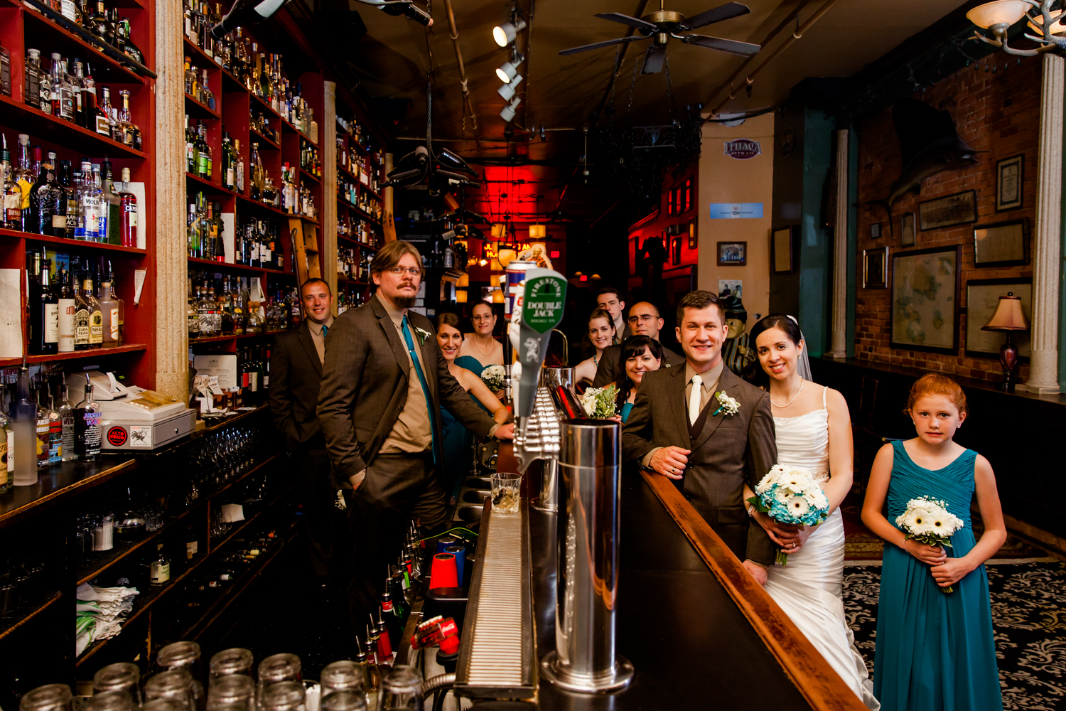  Bridal party stands around a bar 