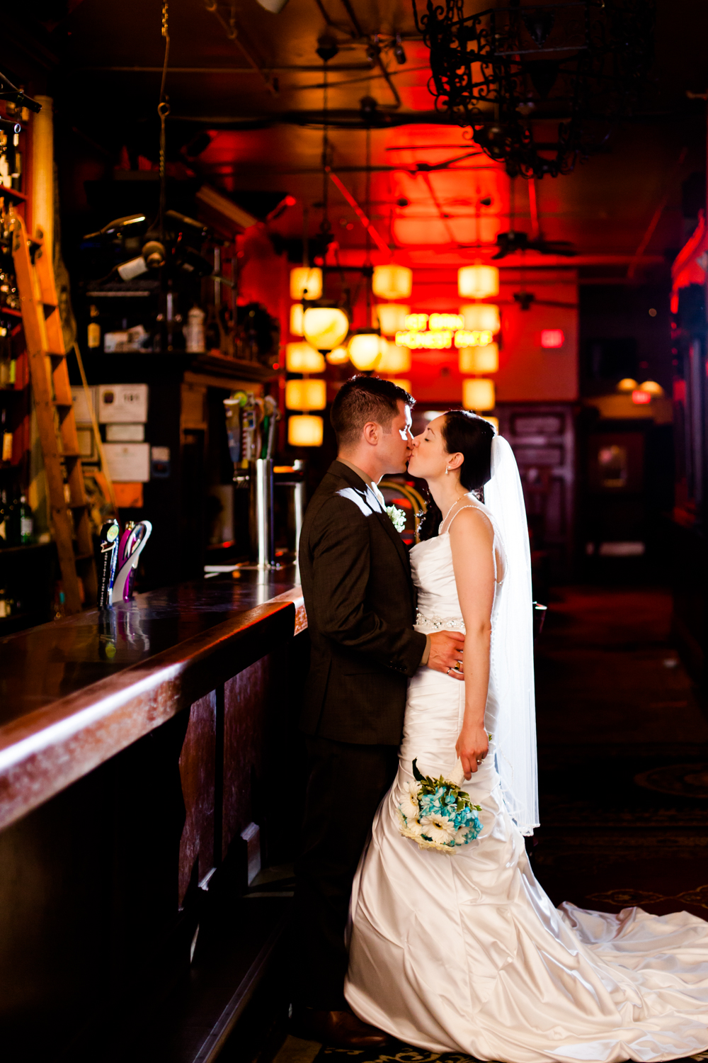  Bride and groom share a kiss at Al's Wine and Whiskey Lounge 