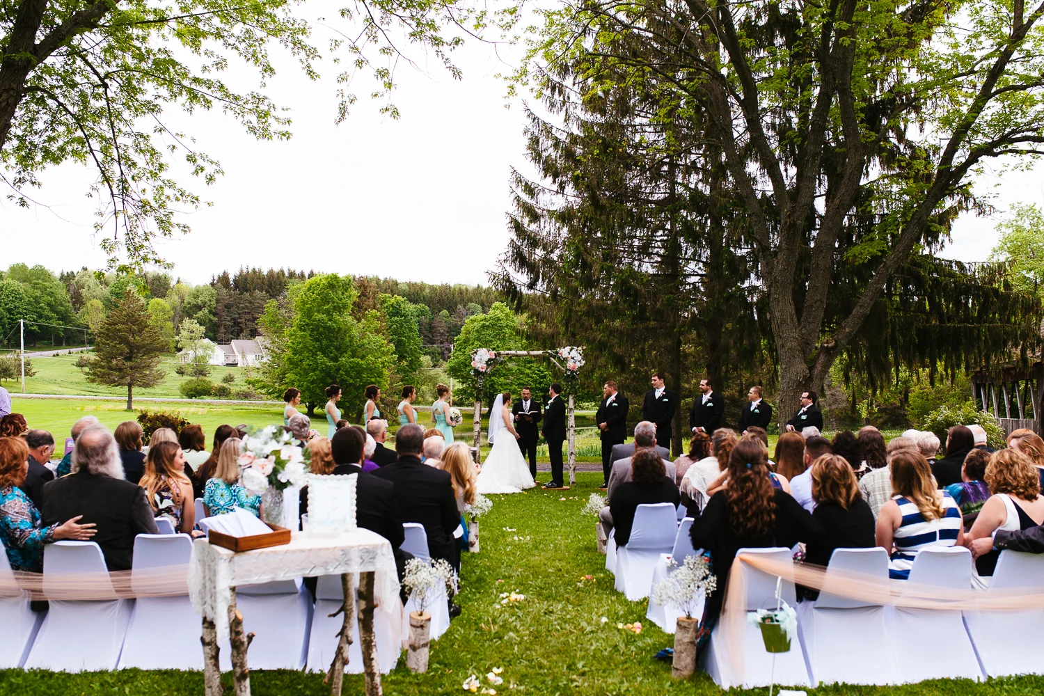 Wide view of an outdoor wedding ceremony.