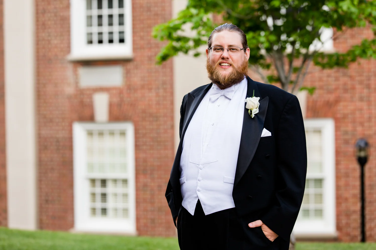 Portrait of a groom. Black tux, white vest.