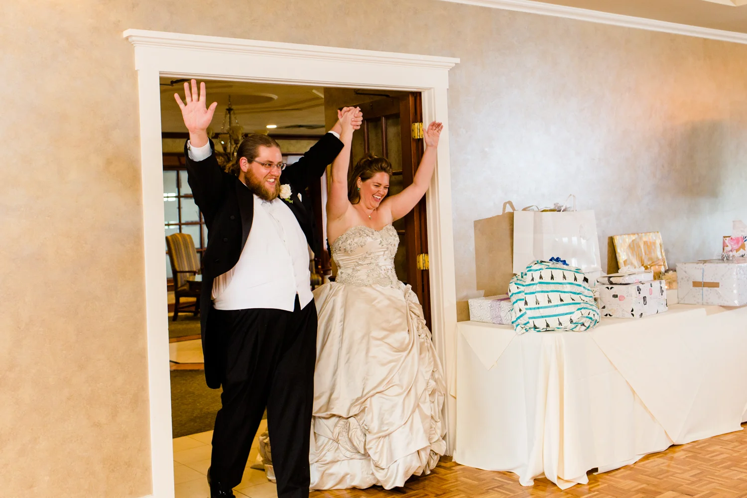 Bride and groom enter their reception hall for the first time as husband and wife. They are at Lakeshore Yacht and Country Club in Cicero, NY.