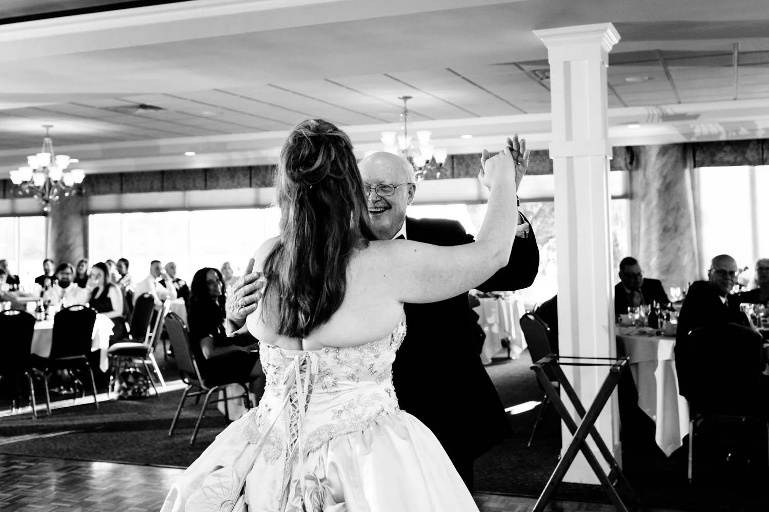 Black and white image of the bride and her father sharing a dance together.
