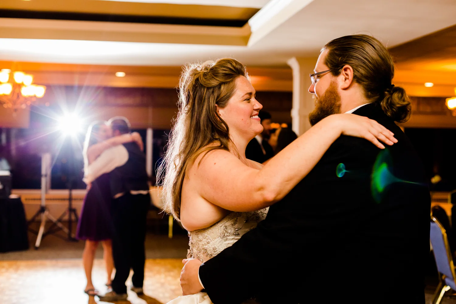 Happy bride and groom dancing image.