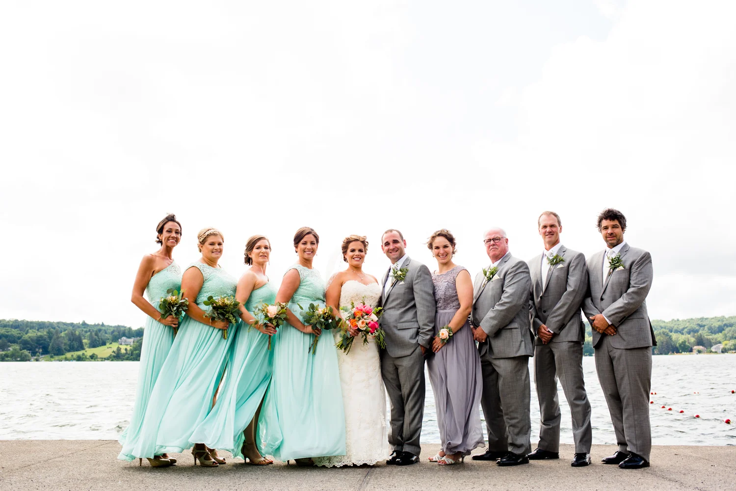 Bridal party in front of a lake.