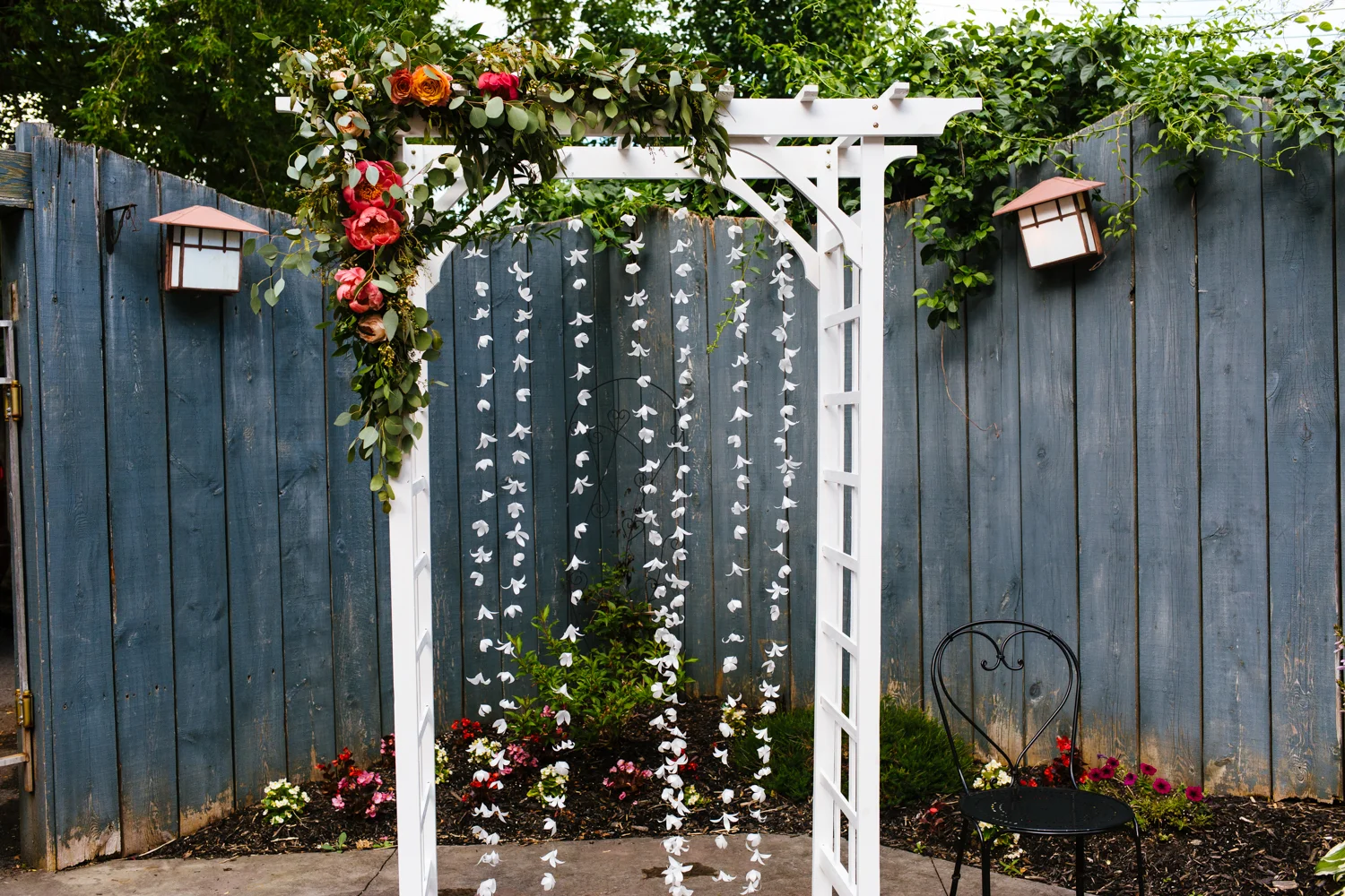 Wedding ceremony arbor adorned with flowers.