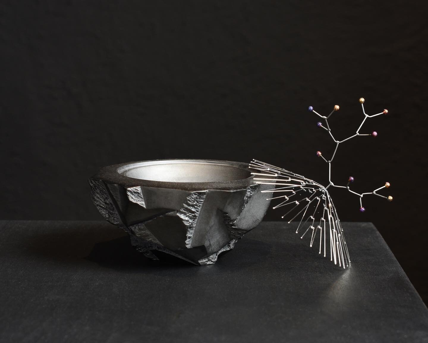 Sheltered Bowl, Winter.  A tiny sculptural vessel. 

  The top portion is comprised of many strands of fine stainless steel, meticulously welded and then highly polished. The finial spheres have a coloration achieved during the welding process by lim