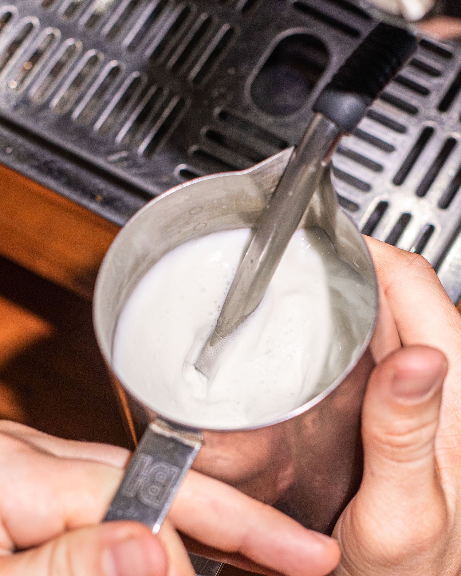 milk being steamed for latte art