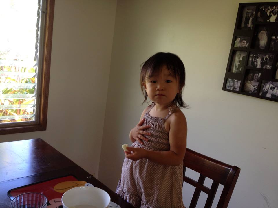 My little hobbit eating egg whites and oranges... her second breakfast. She looks like she's ready to sing a verse.
