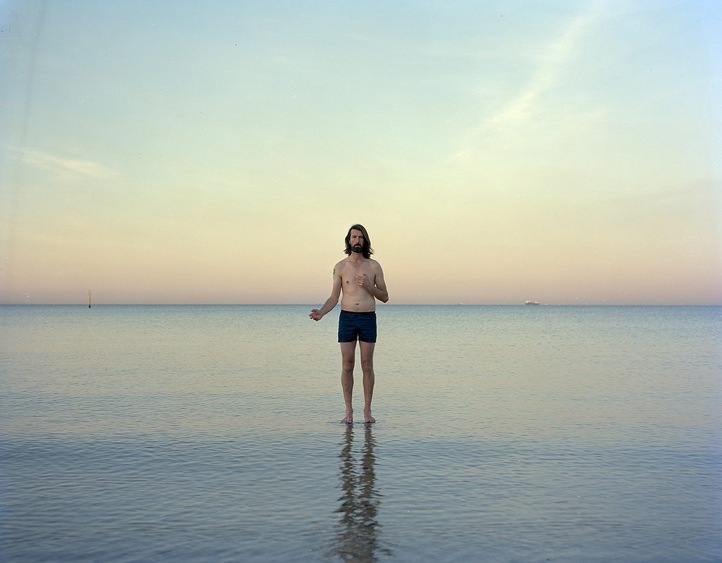 Ross COULTER, "...He walks on water ", 2013 from the series Aussie Jesus chromogenic print 100.0 x 127.0 cm courtesy of the artist Artist’s statement: Drawing on what many consider the first direct self-portrait in the western tradition, the series Aussie Jesus refers to Albrecht Dürer’s iconic painted self-portrait (1500). The photograph attempts to confront the role of the artist, representations of Jesus and notions of Australian identity.