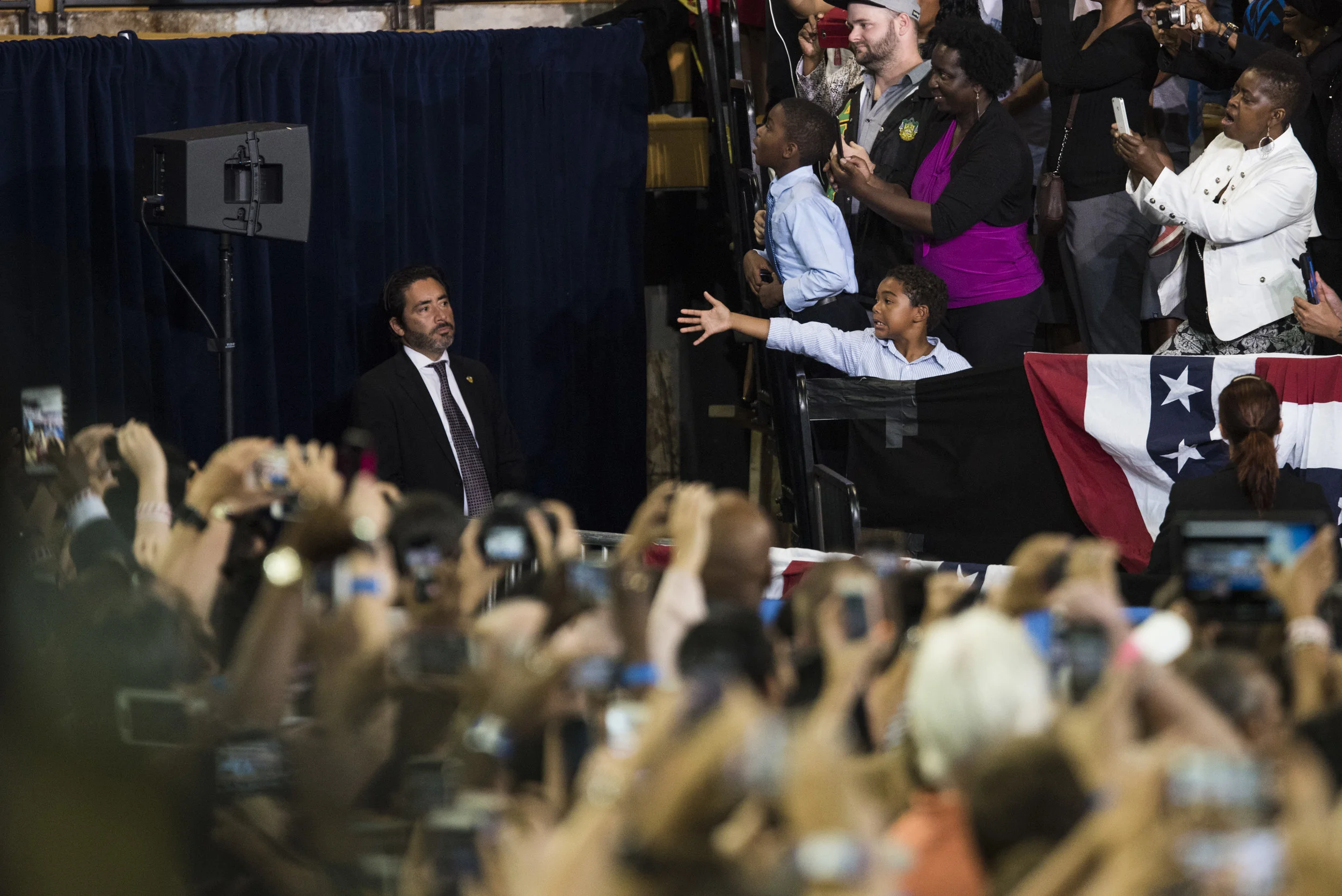 I saw this kid about 2 minutes before President Obama took the stage. I knew he was entering the stage from that side so I was hoping he would get a handshake from the president...