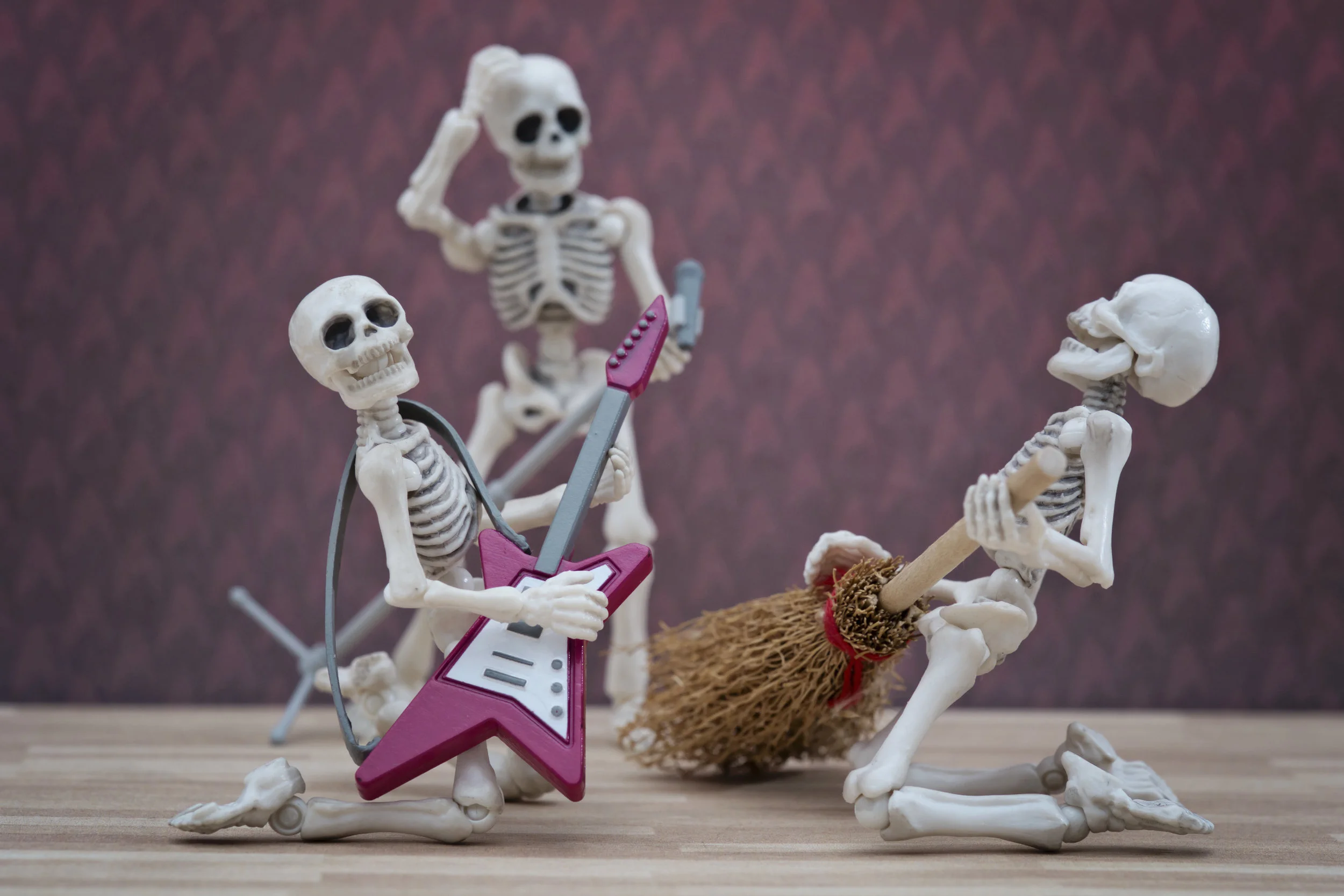 Skeleton playing broom as guitar