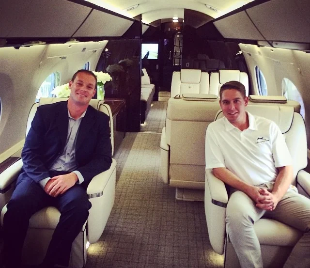 The annual National Business Aviation Association Conference includes a large static display of aircraft that attendees have the opportunity to tour. Elite Air Sales Director AJ Becker (left) and Lear 31 Captain Blake Spencer (right) are shown here aboard a Bombardier Challenger 605, an industry leading heavy jet.