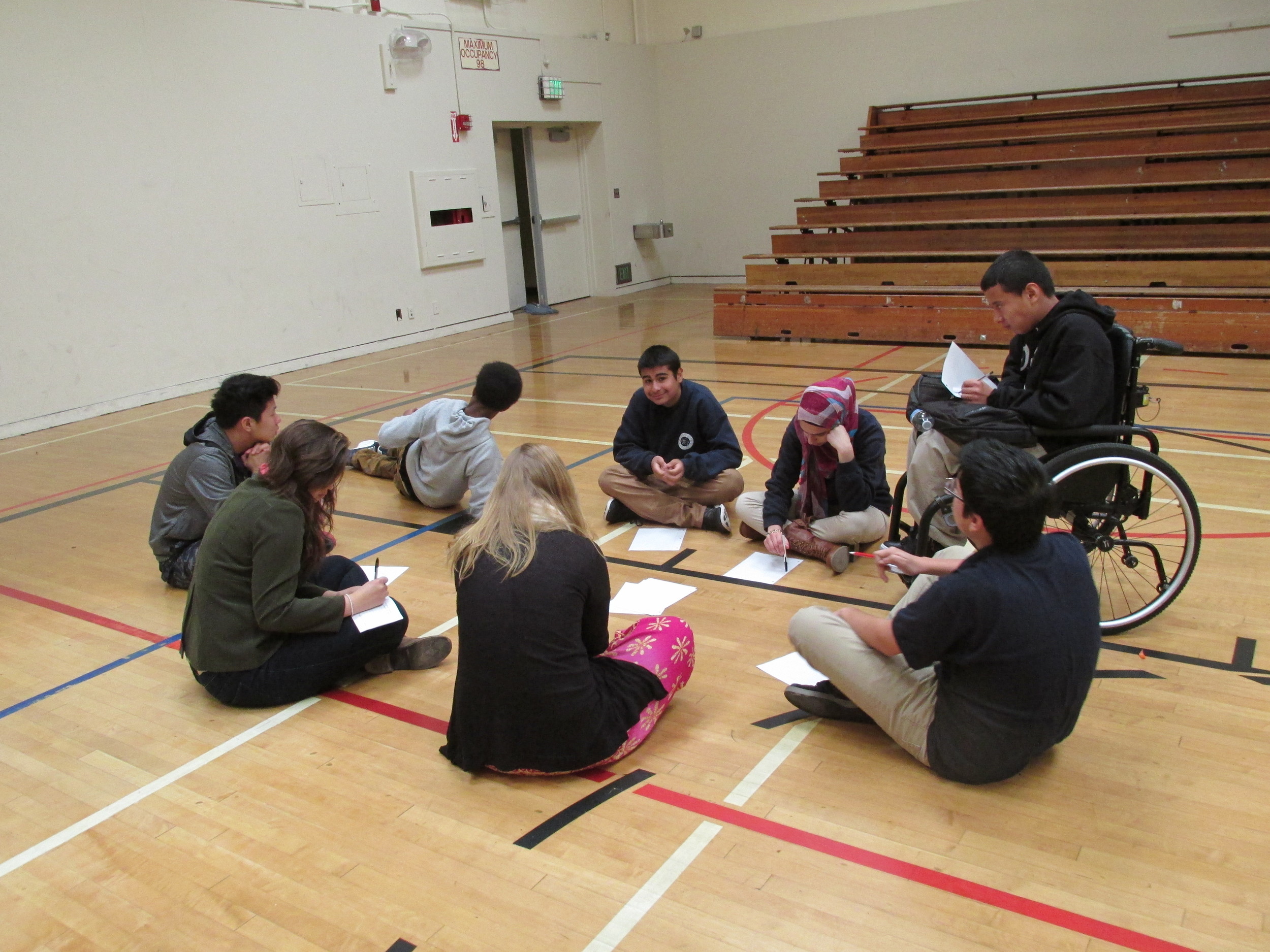 Sara and Adeline Leading a group. Students are writting down their serious story.