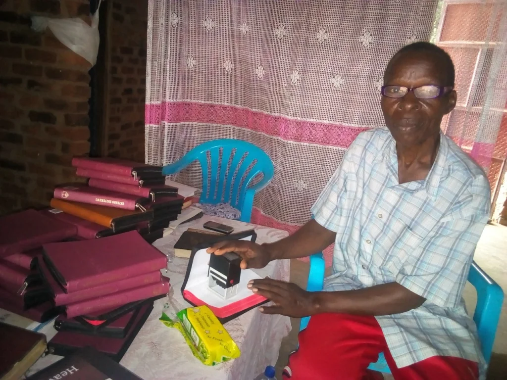 Pr Katandi lebaling every bible by stamping on each.2.jpg