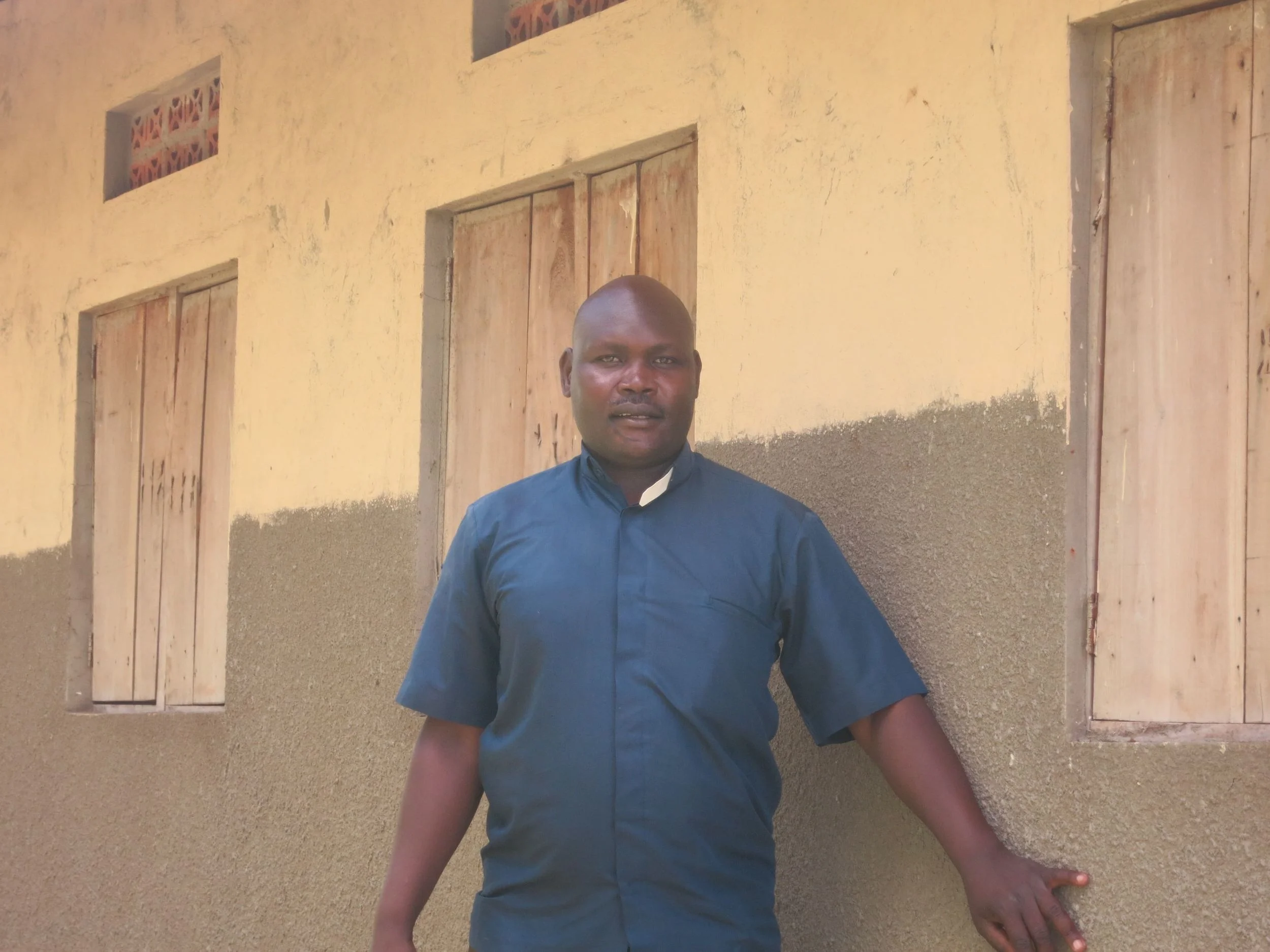Fr. James stands proudly in front of St. Catherine's Nursery School (April 2015)