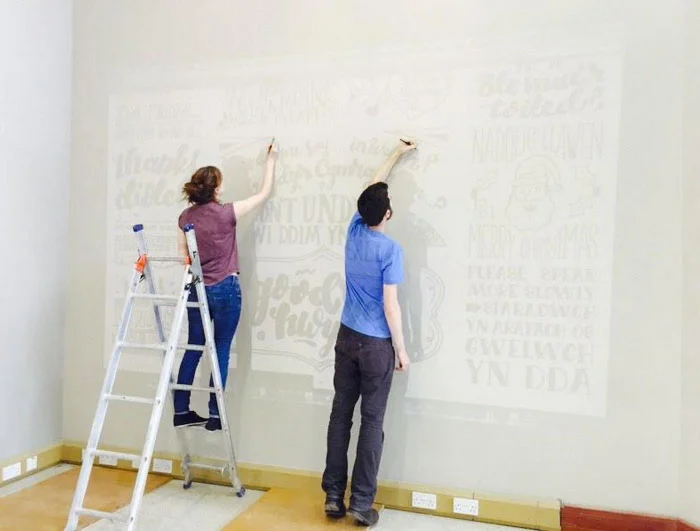 We started by projecting our sketches up onto the walls to get the scale right. We sketched a rough outline for us to fill in with paint.